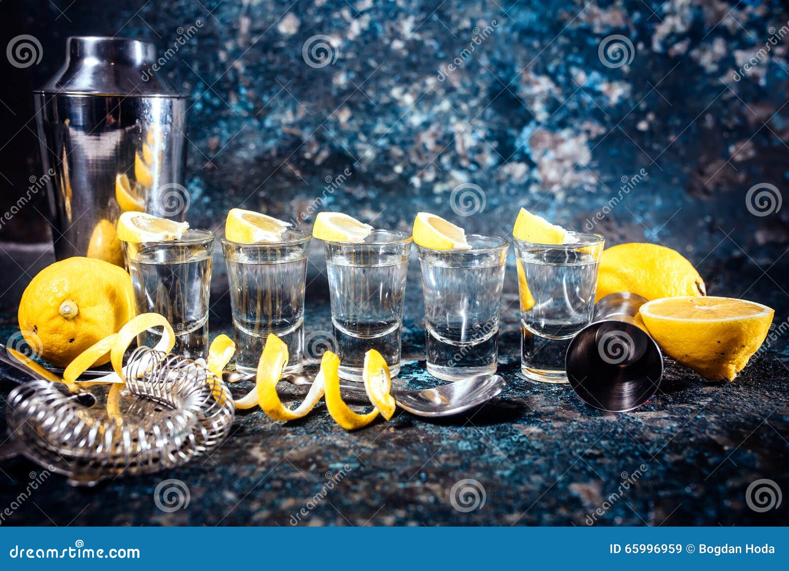 tequila shots with lemon slices and cocktail s. alcoholic drinks in shot glasses served in pub or bar