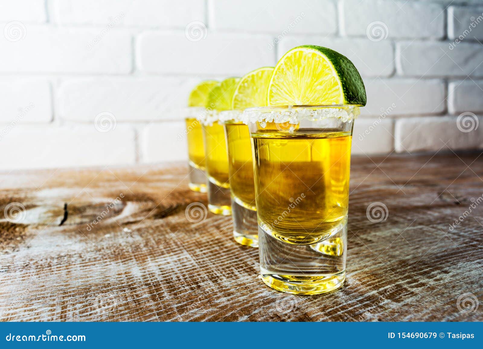 Tequila Shots on the Rustic Wooden Table and Painted Brick Wall Stock ...