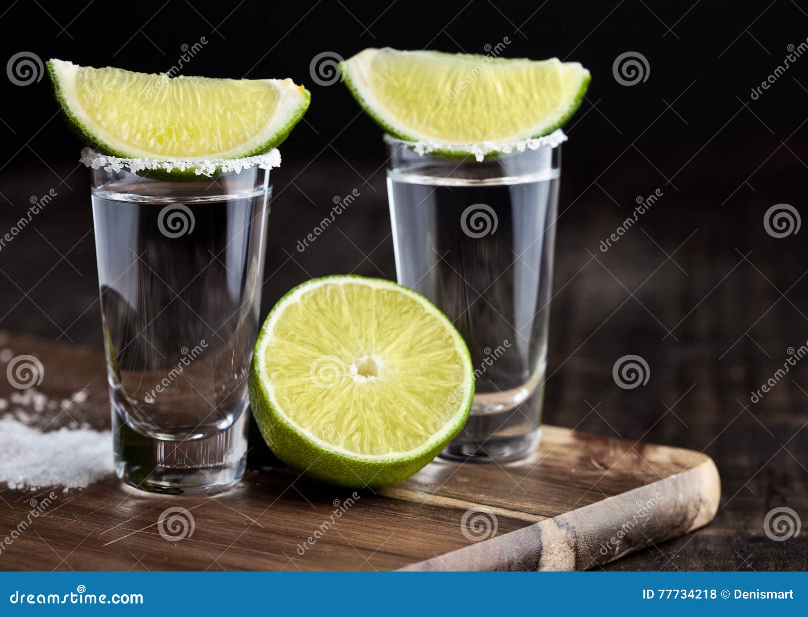 Tequila Silver Shots with Lime Slices and Salt on Wooden Board Stock ...