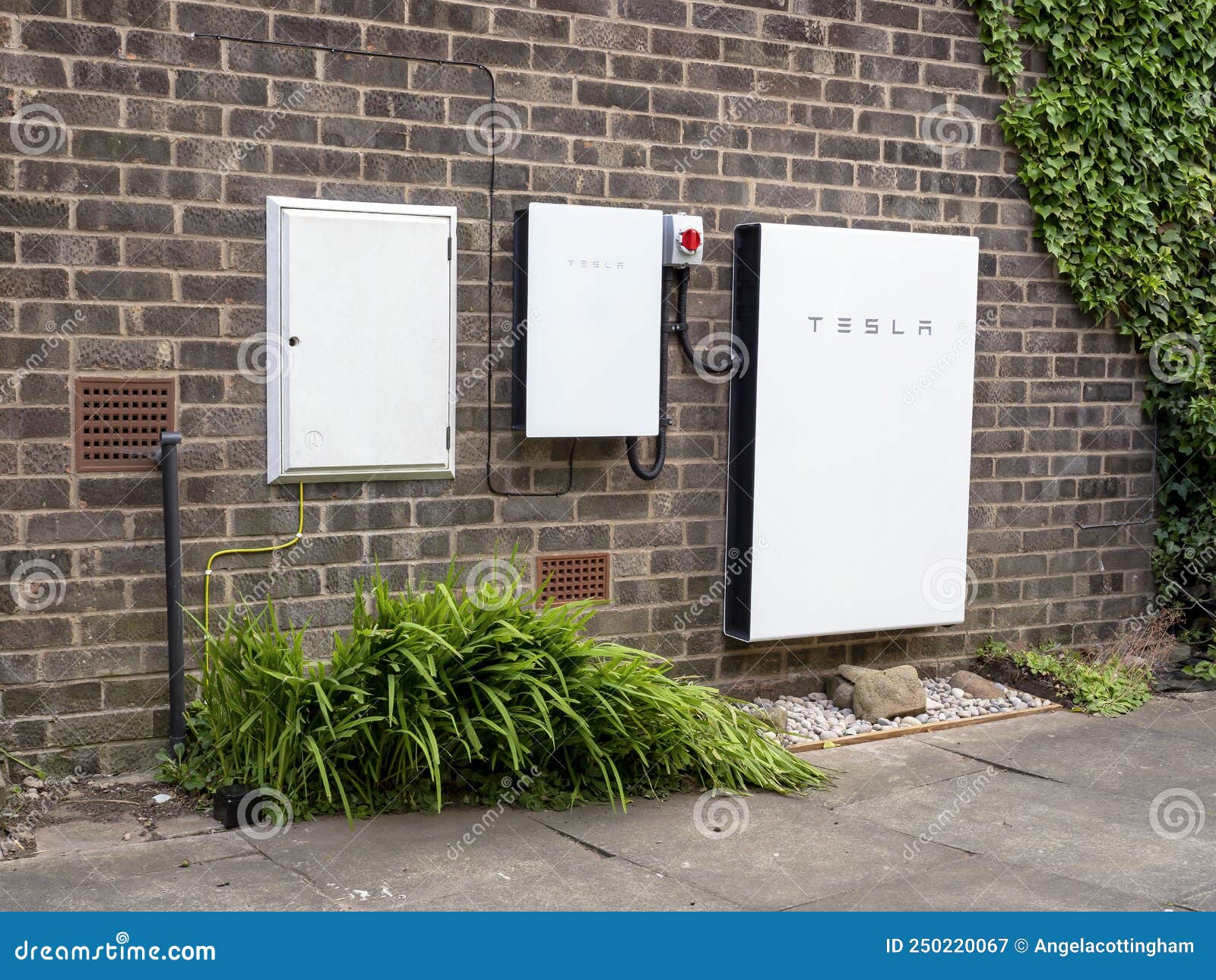Tesla Powerwall 2 and Backup Gateway 2 on a House Wall Editorial