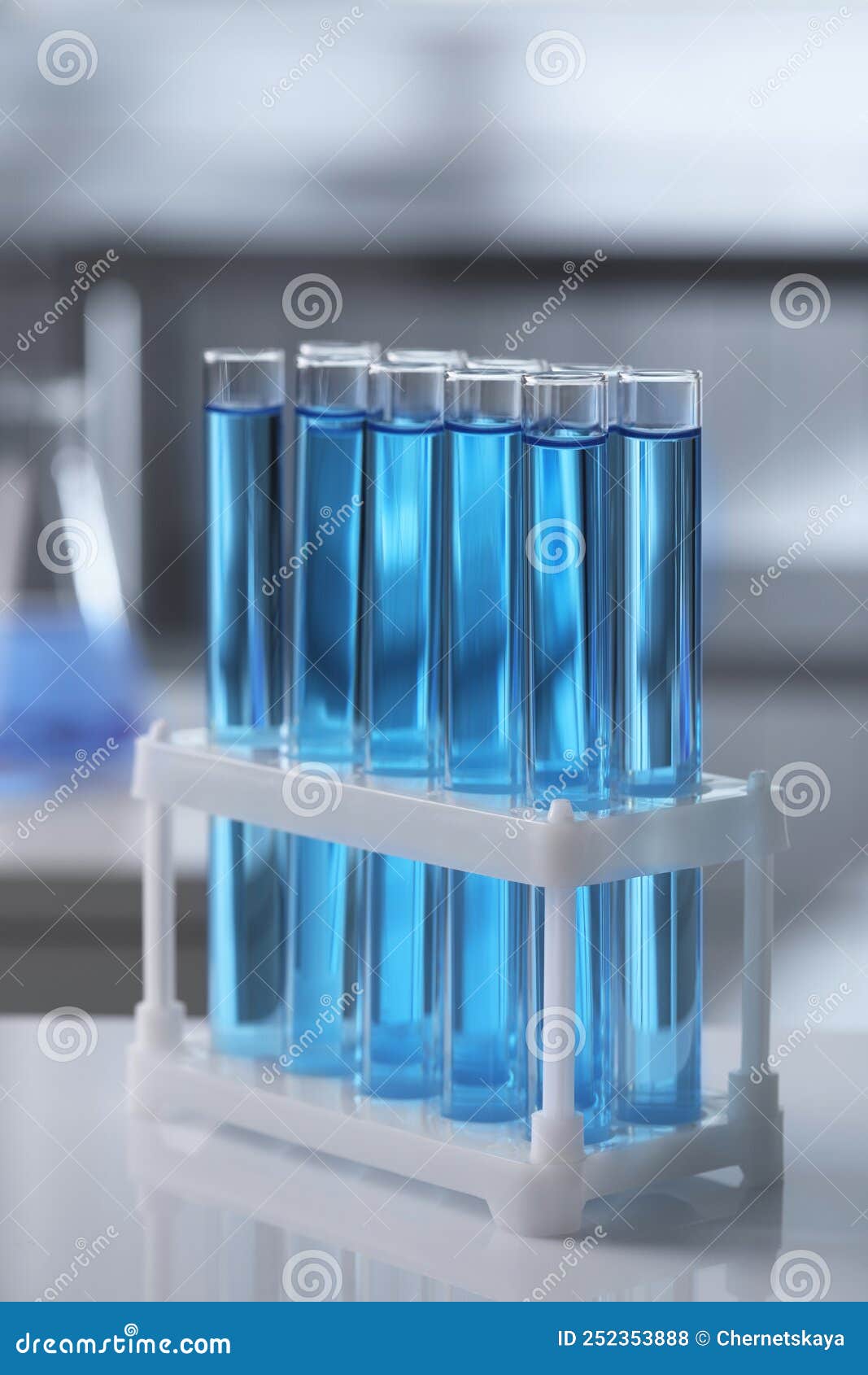 Test Tubes with Light Blue Liquid on Table in Laboratory Stock Photo Image of blurred, fluid