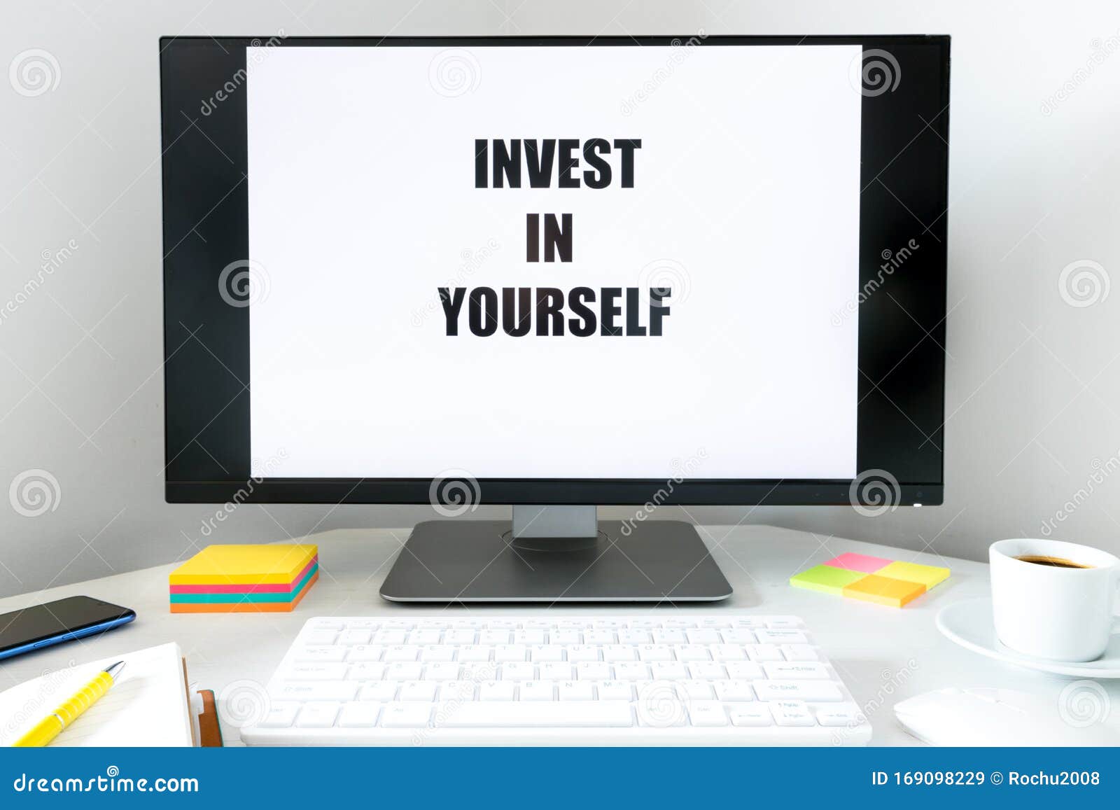 Text Displayed On The Monitor Invest In Yourself A Desk With A