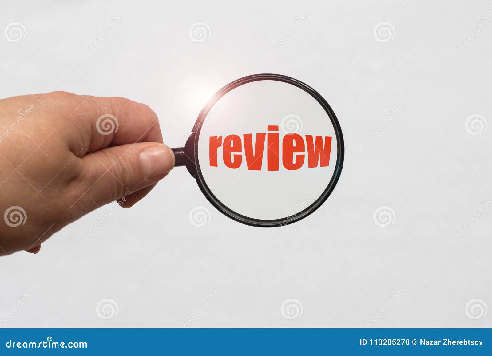Text Review and a Magnifying Glass on White Background Stock Photo