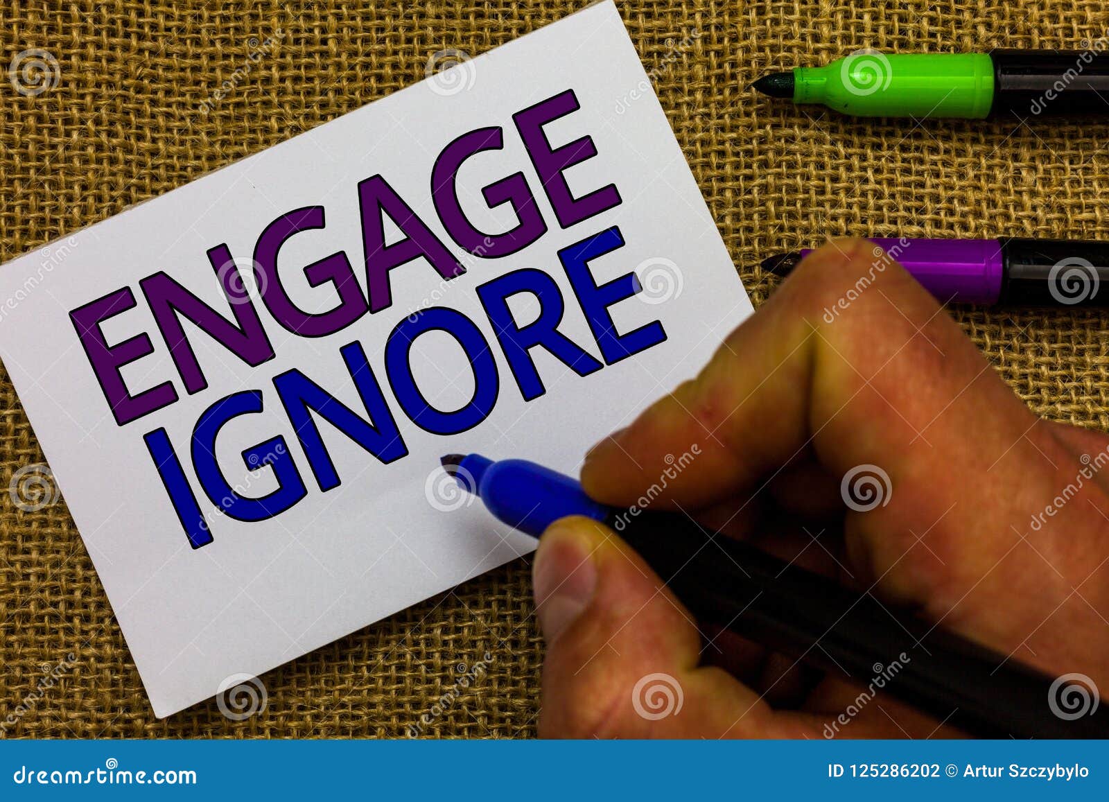 text sign showing engage ignore. conceptual photo silent treatment manipulative punishment sulking shunning man hand holding marke