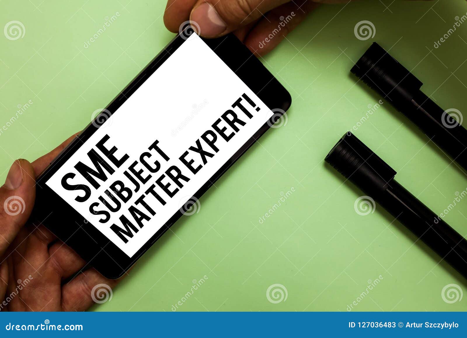text sign showing sme subject matter expert. conceptual photo authority in a particular area or topic domain man's hand hold ipho