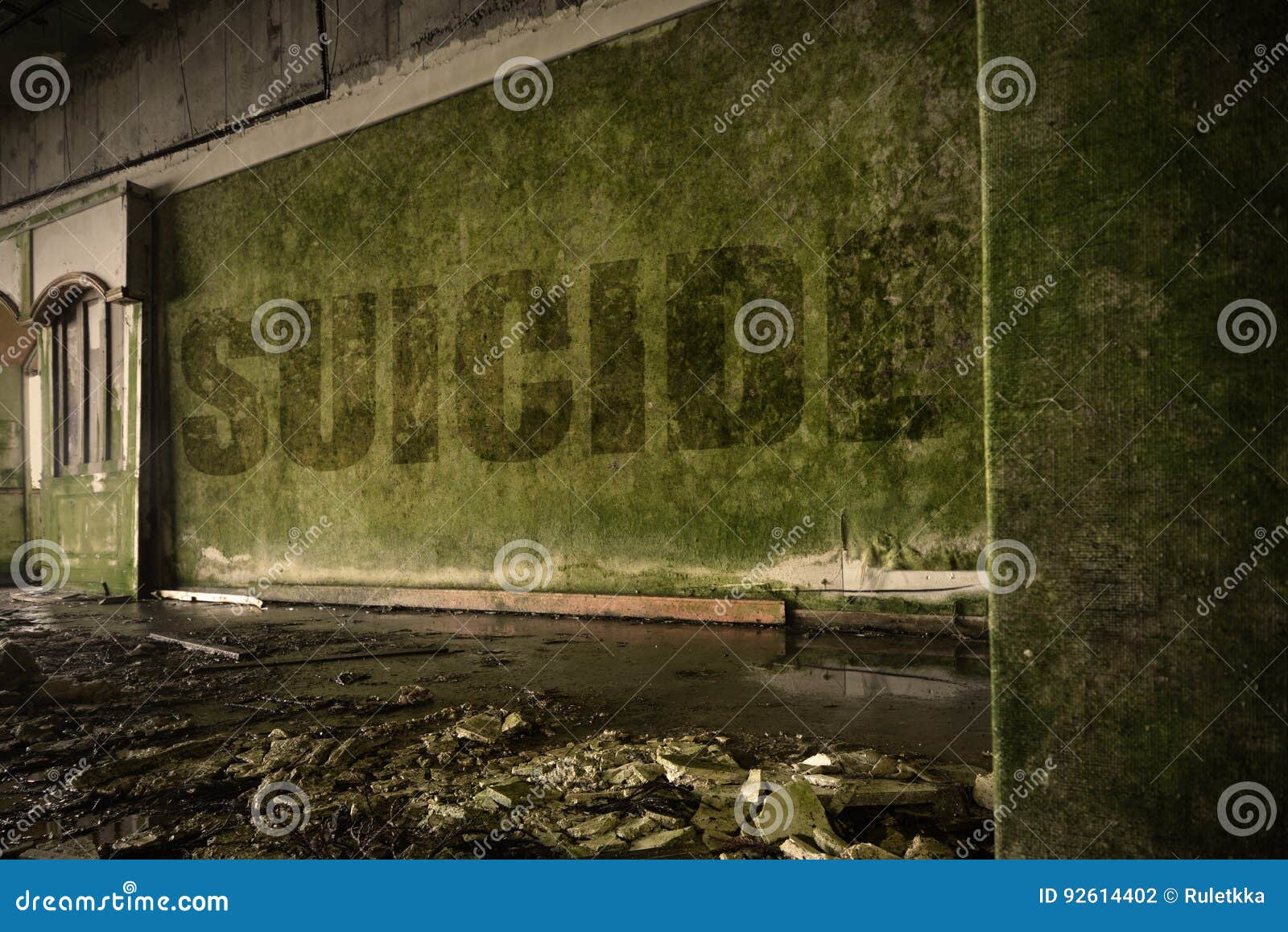 text suicide on the dirty wall in an abandoned ruined house