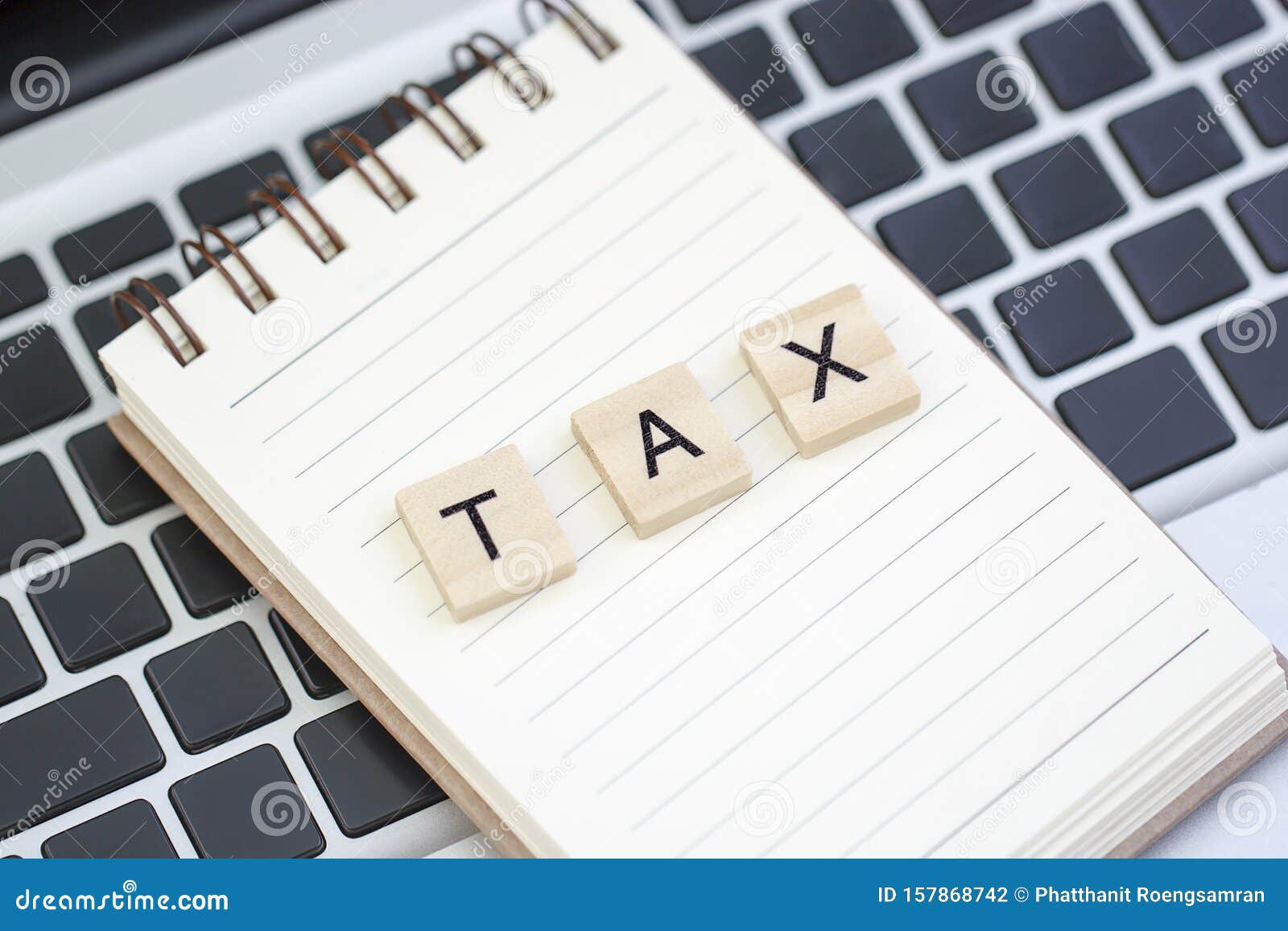 Text TAX Made from Wood on Notebook and on Laptop Stock Photo Image