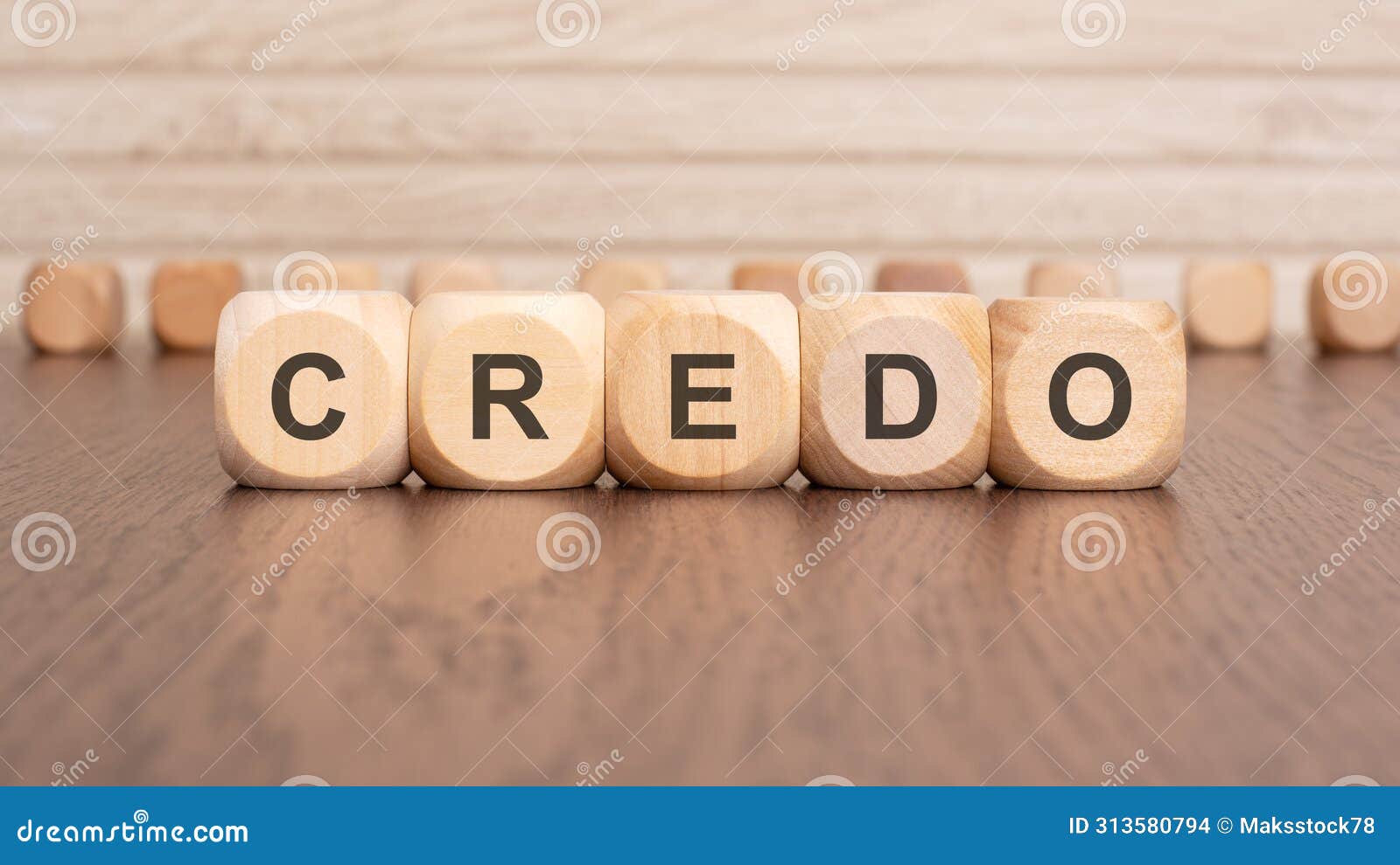 the text 'credo' is written on wooden cubes on a brown background