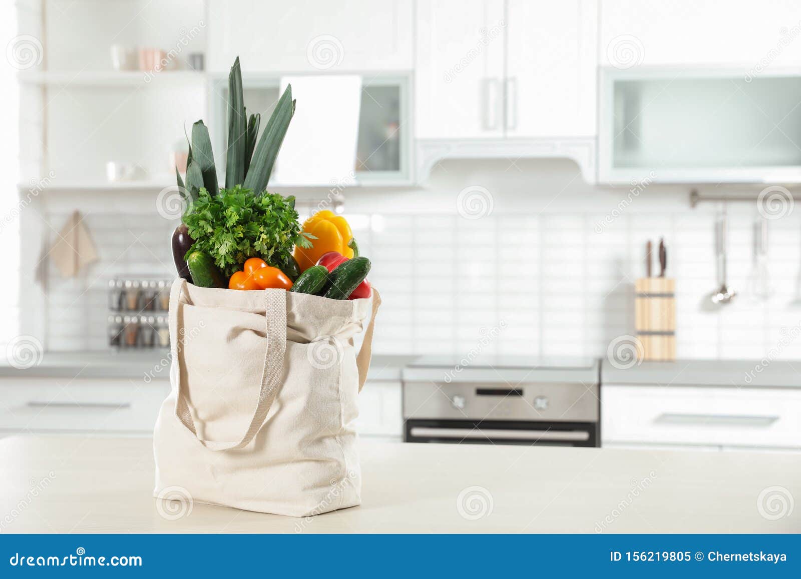 Textile Shopping Bag Full of on Table in Kitchen. Space for Text Stock