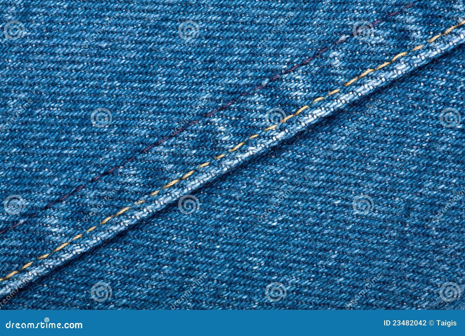 Textura de los pantalones vaqueros. Textura azul gastada de los pantalones vaqueros del dril de algodón con la puntada