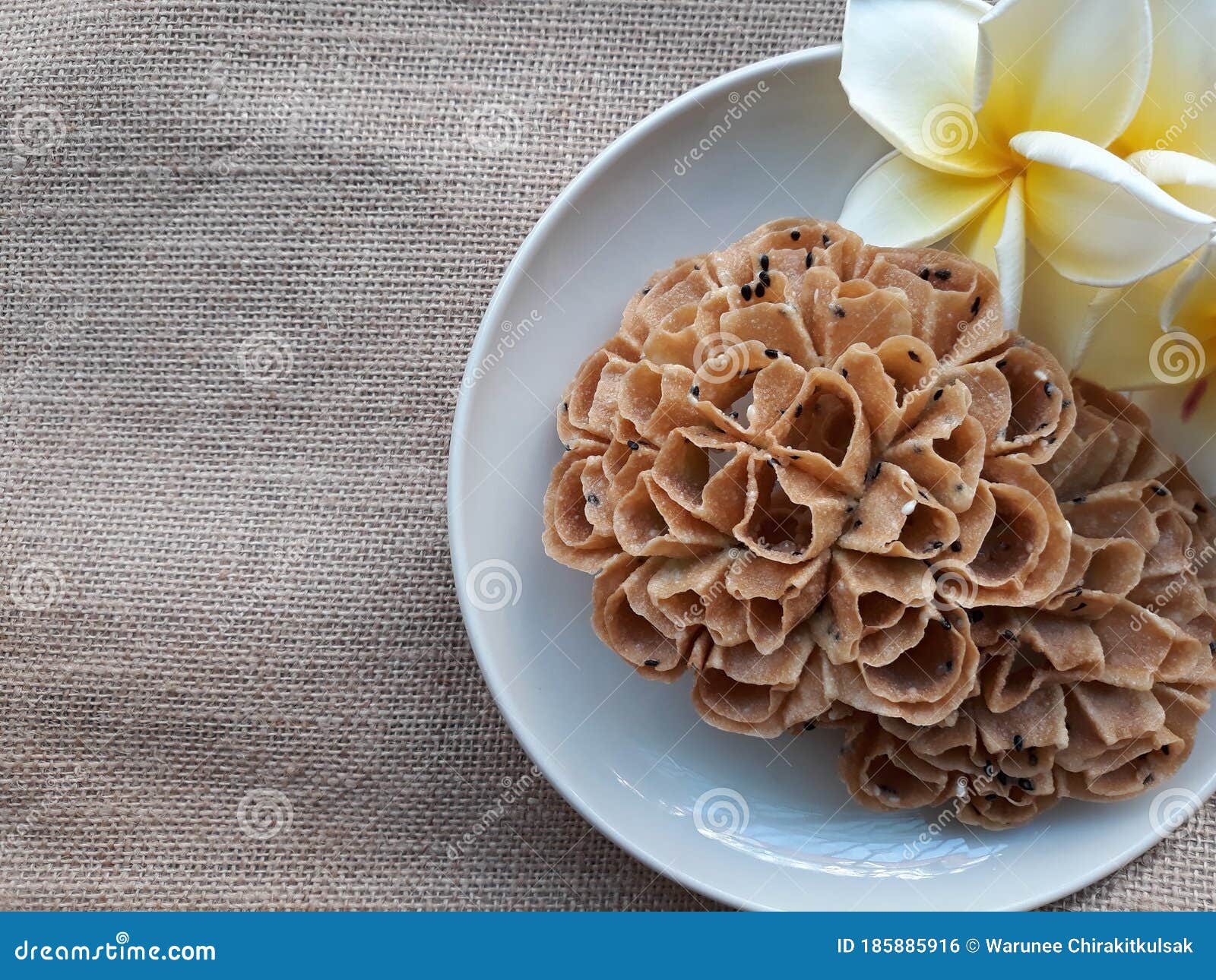 texture background of thai snacks name "kanom dork jork" on a dish with flowers. space for text