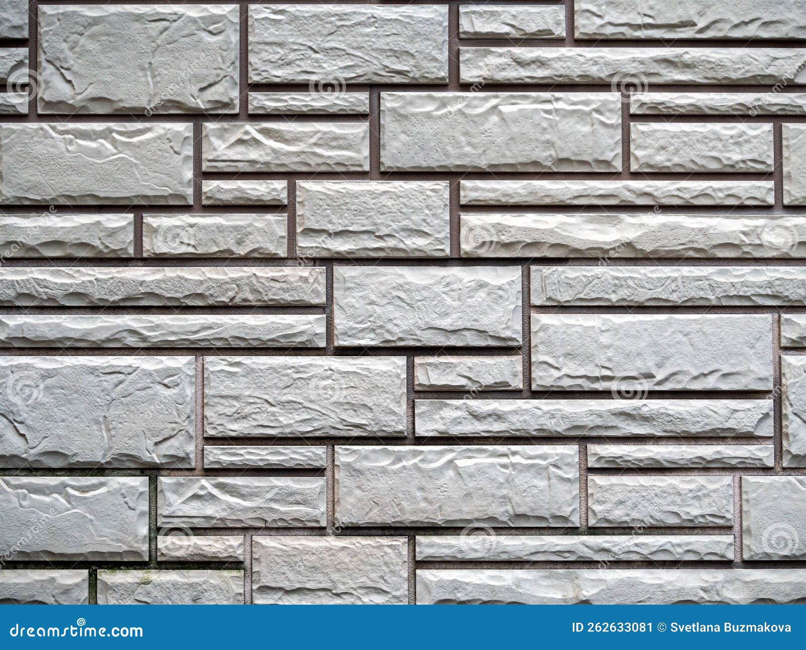 Texture of Decorative Tiles Lined with Brickwork. Gray Rough Tiles of Different Sizes Create a
