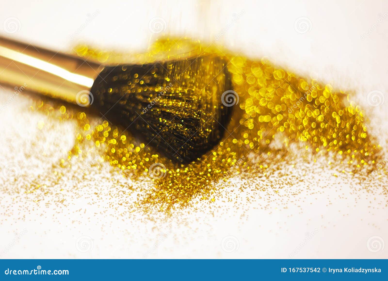 Texture of Gold Glitter on the Makeup Brush and Design. on White