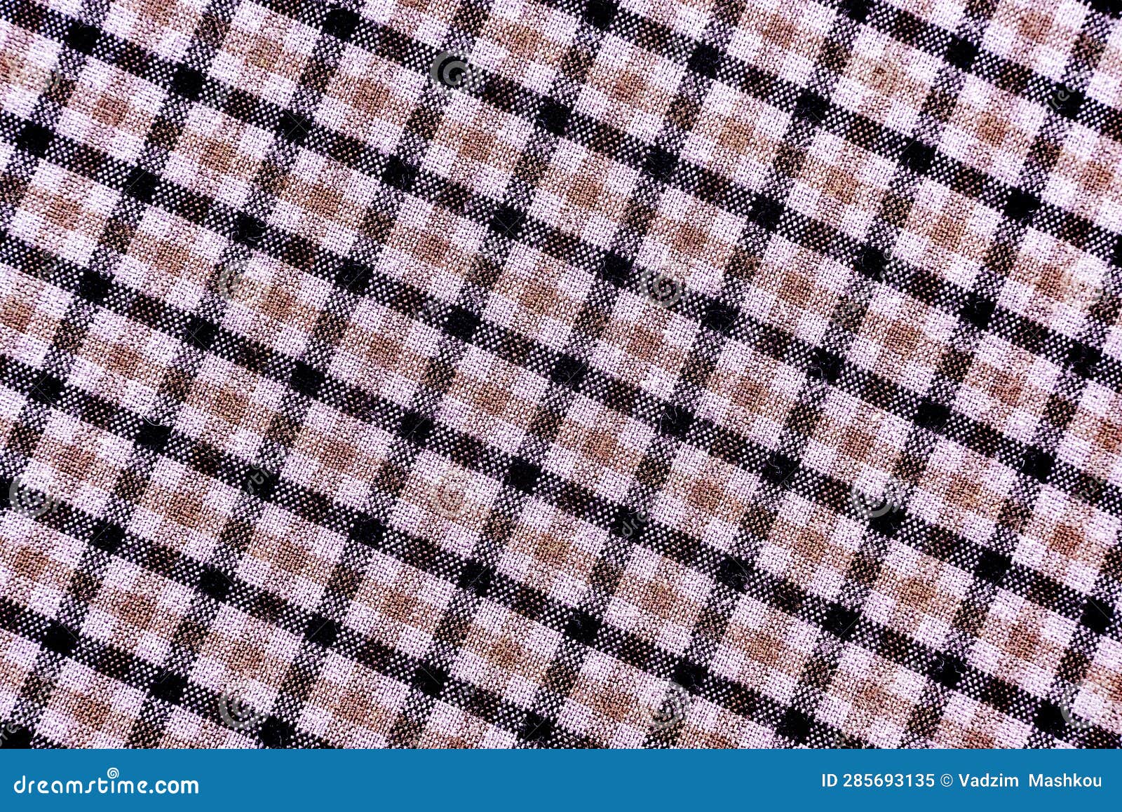the texture of linen fabric in a large cell of black and brown. scottish tailoring material. checkered fabric