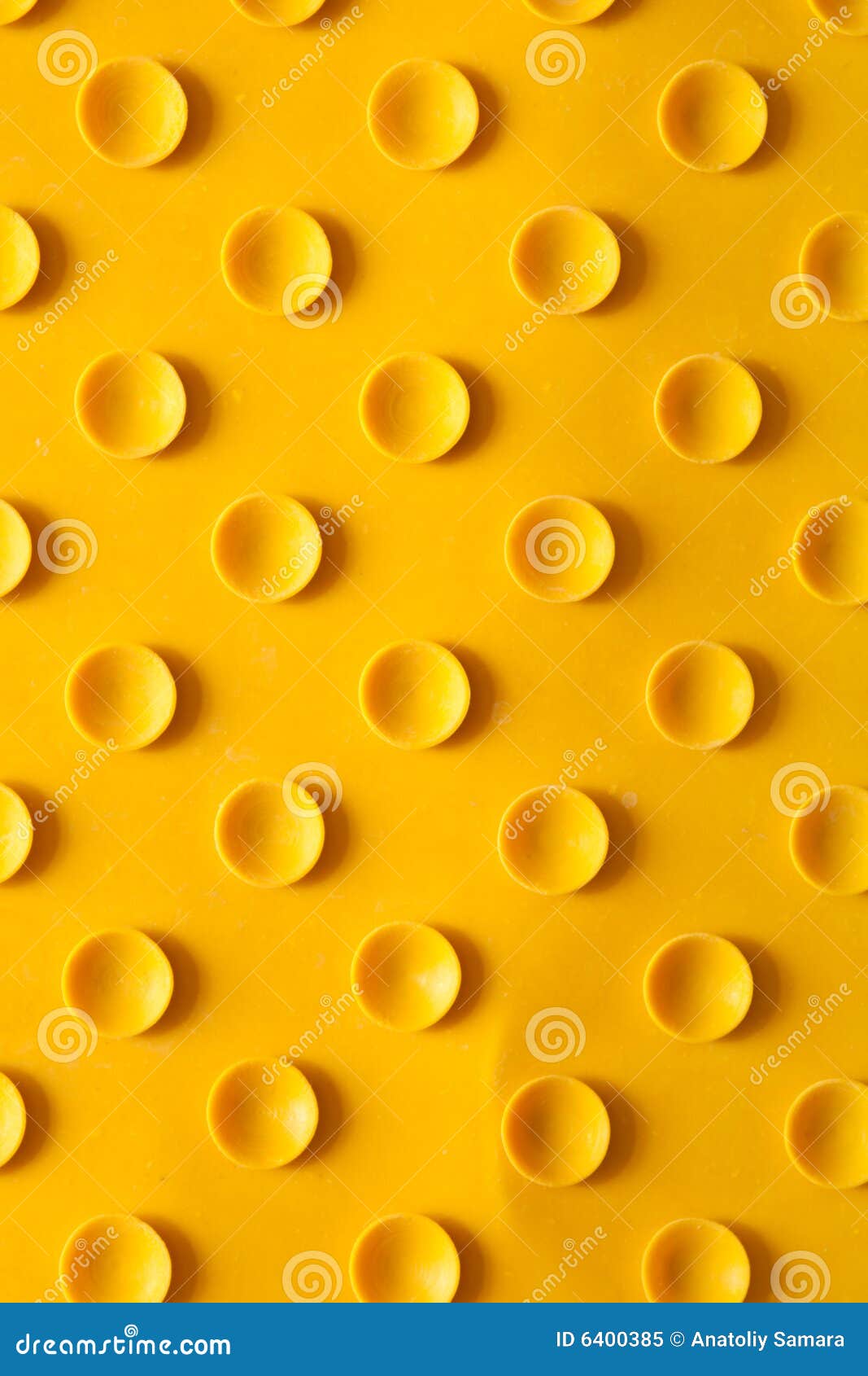 Texture of a rubber rug with suckers. Texture of a yellow rubber rug with suckers