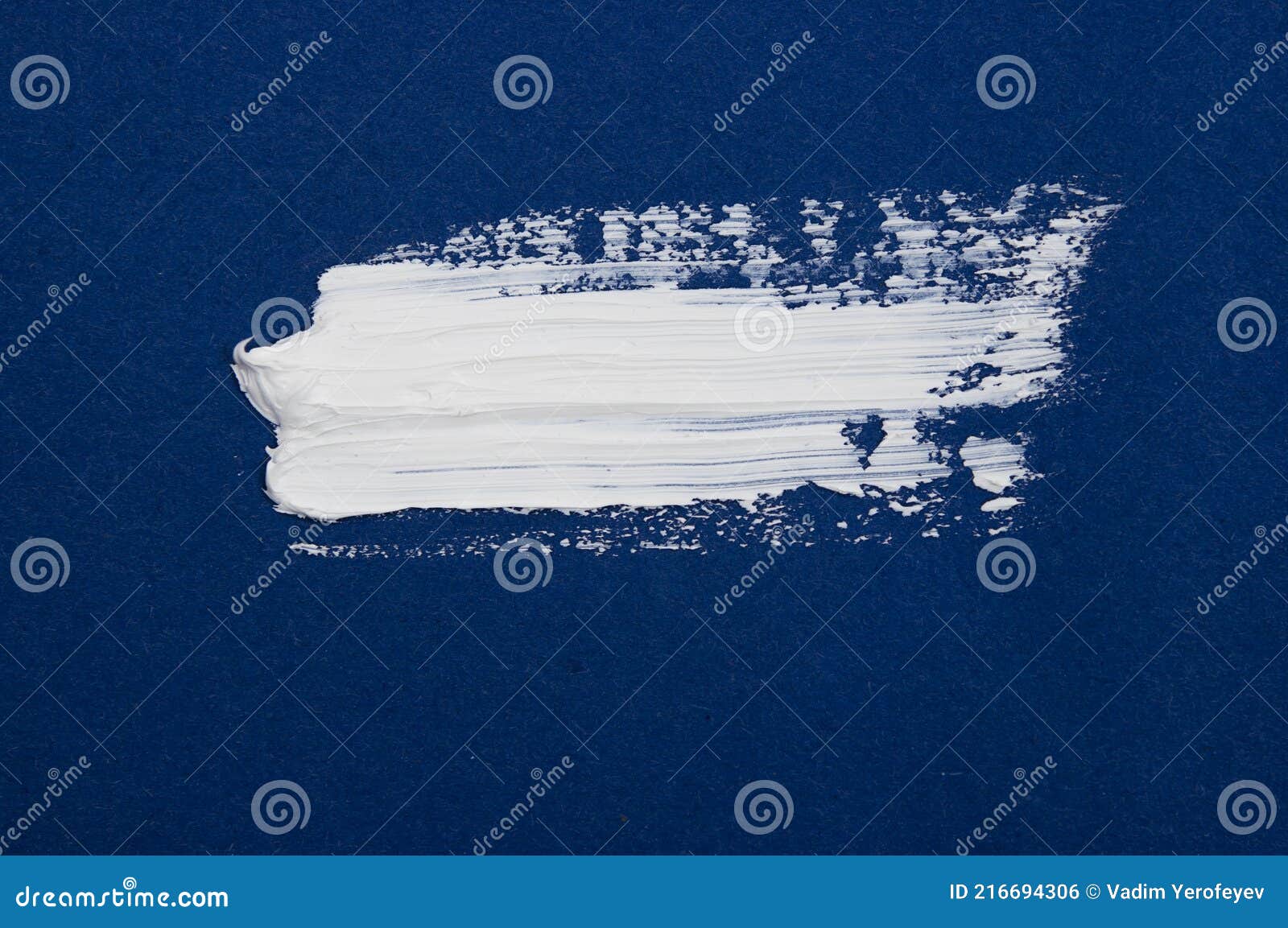 Structural Paint White on a Blue Background. Paint To Smear. Brush