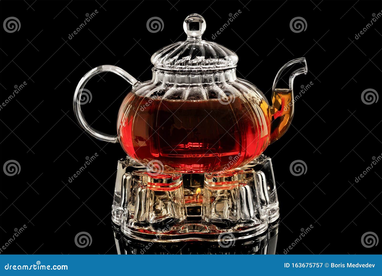 Thé En Verre Sur Un Mirador Chauffé à La Bougie Sur Fond Noir, Thé Noir  Dans Une Théière En Verre Image stock - Image du rempli, flamme: 163675757