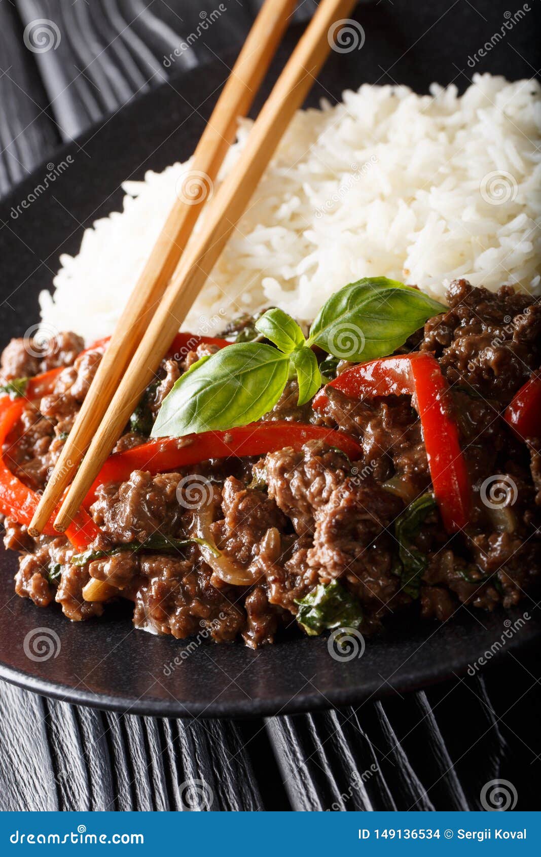 Thai Basil Beef, or Pad Gra Prow with Rice Side Dish Closeup. Vertical