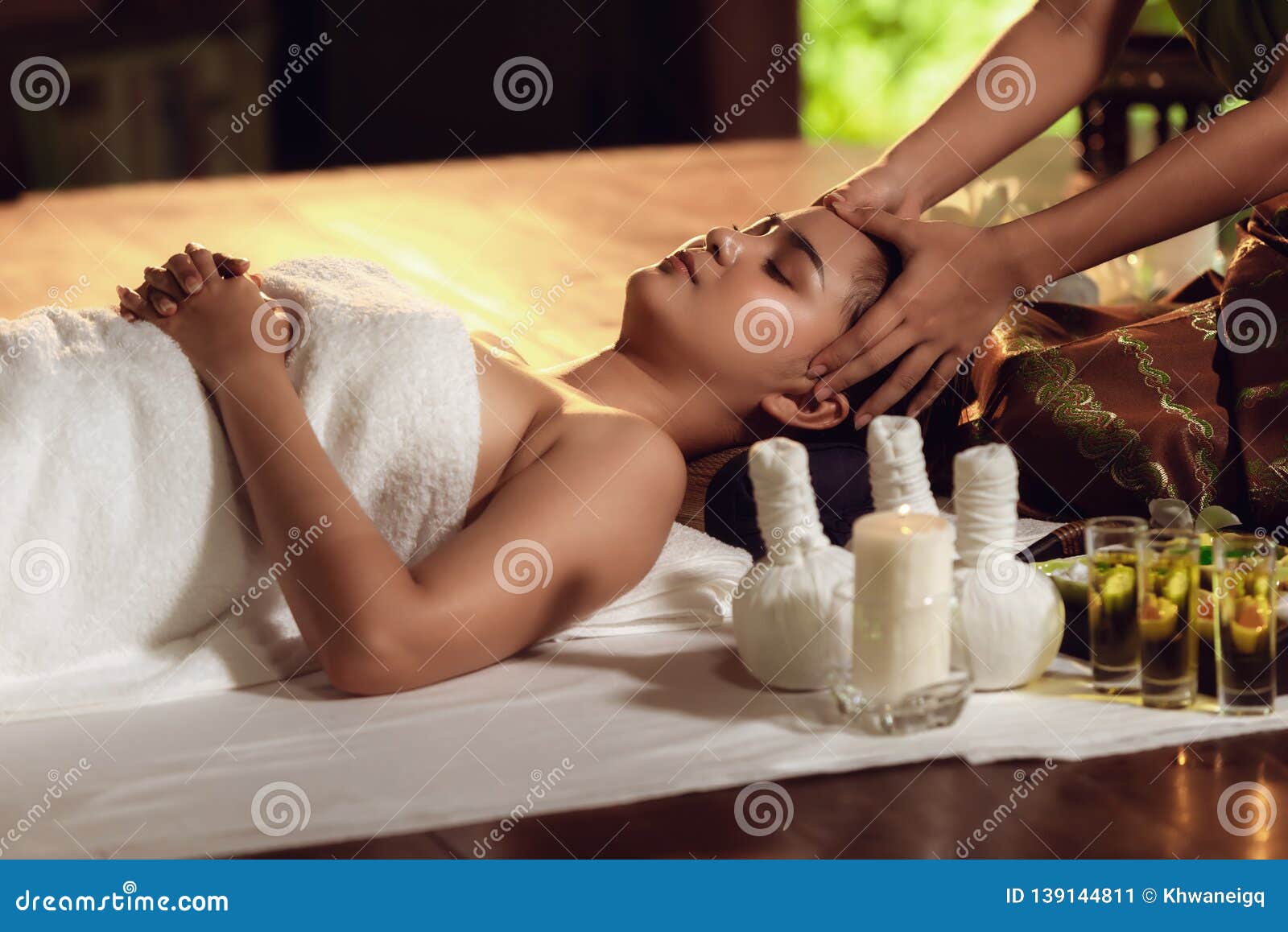 thai body spa massage with aroma herbs., pretty attractive asian woman is relaxing by beauty skin care after traveling in thailand