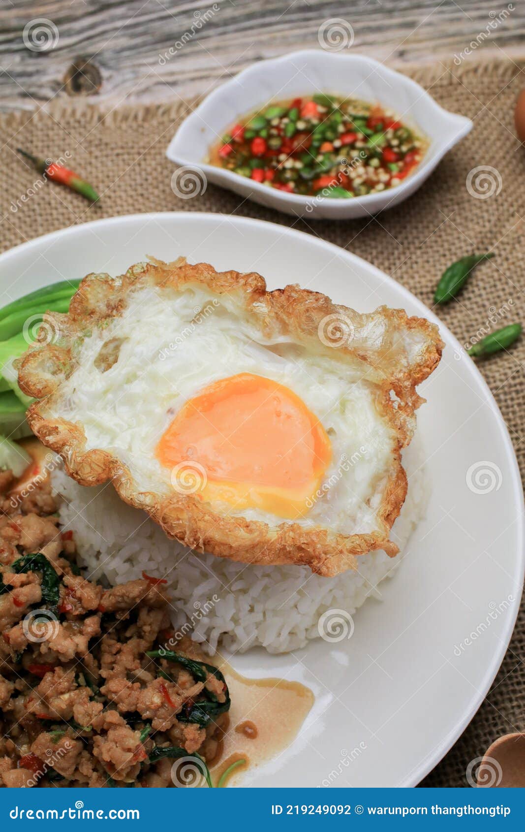 thai stir fried  basil with minced pork, chili and fried egg on topped rice.