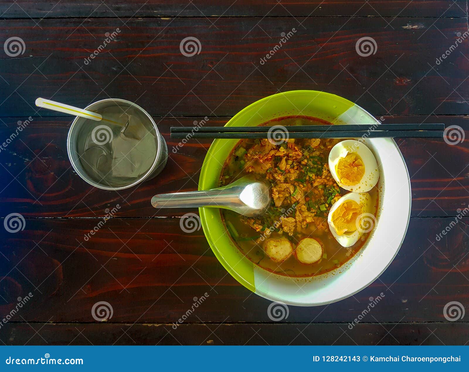 thai style chopped pork noodle garnished with pork balls, half-cutted boiled egg