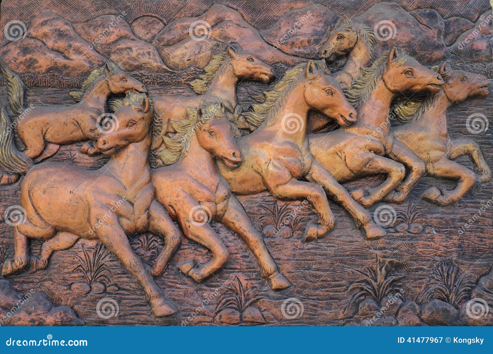 Low relief cement Thai style handcraft of horse on wall.