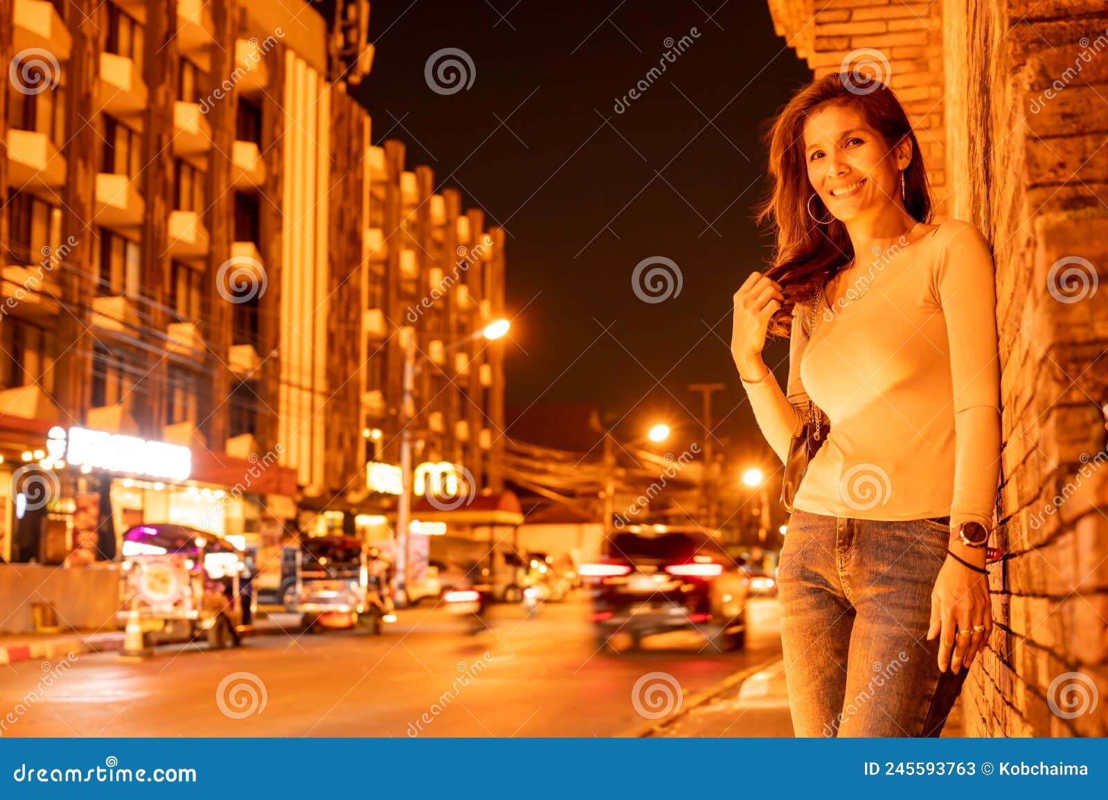 thai woman with old brick wall in the evening