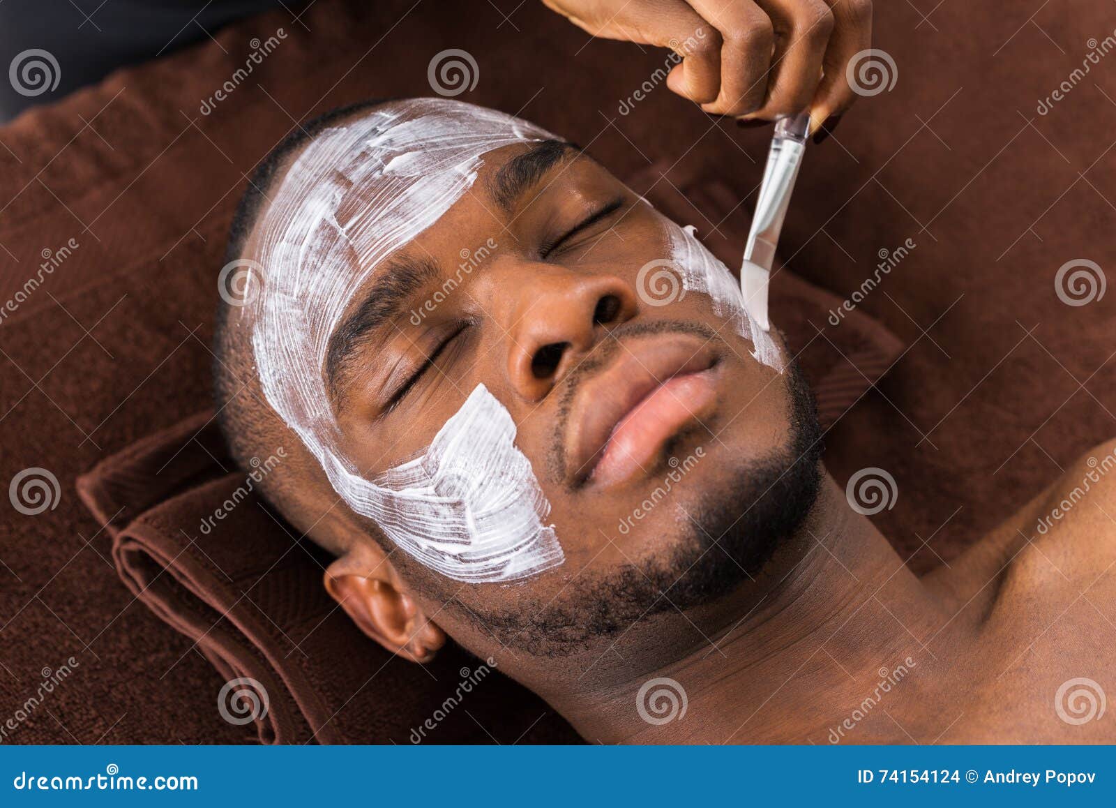 therapist applying face mask to man