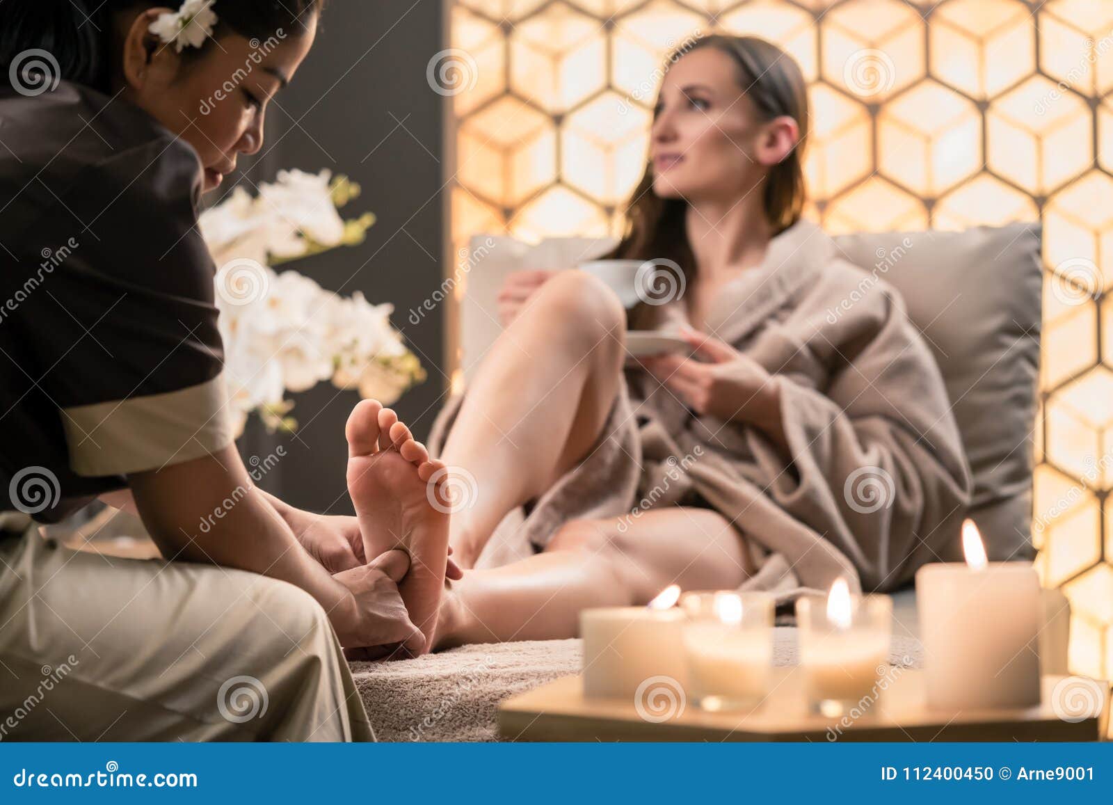 Therapist Massaging The Foot Of A Female Client In Asian Beauty Stock