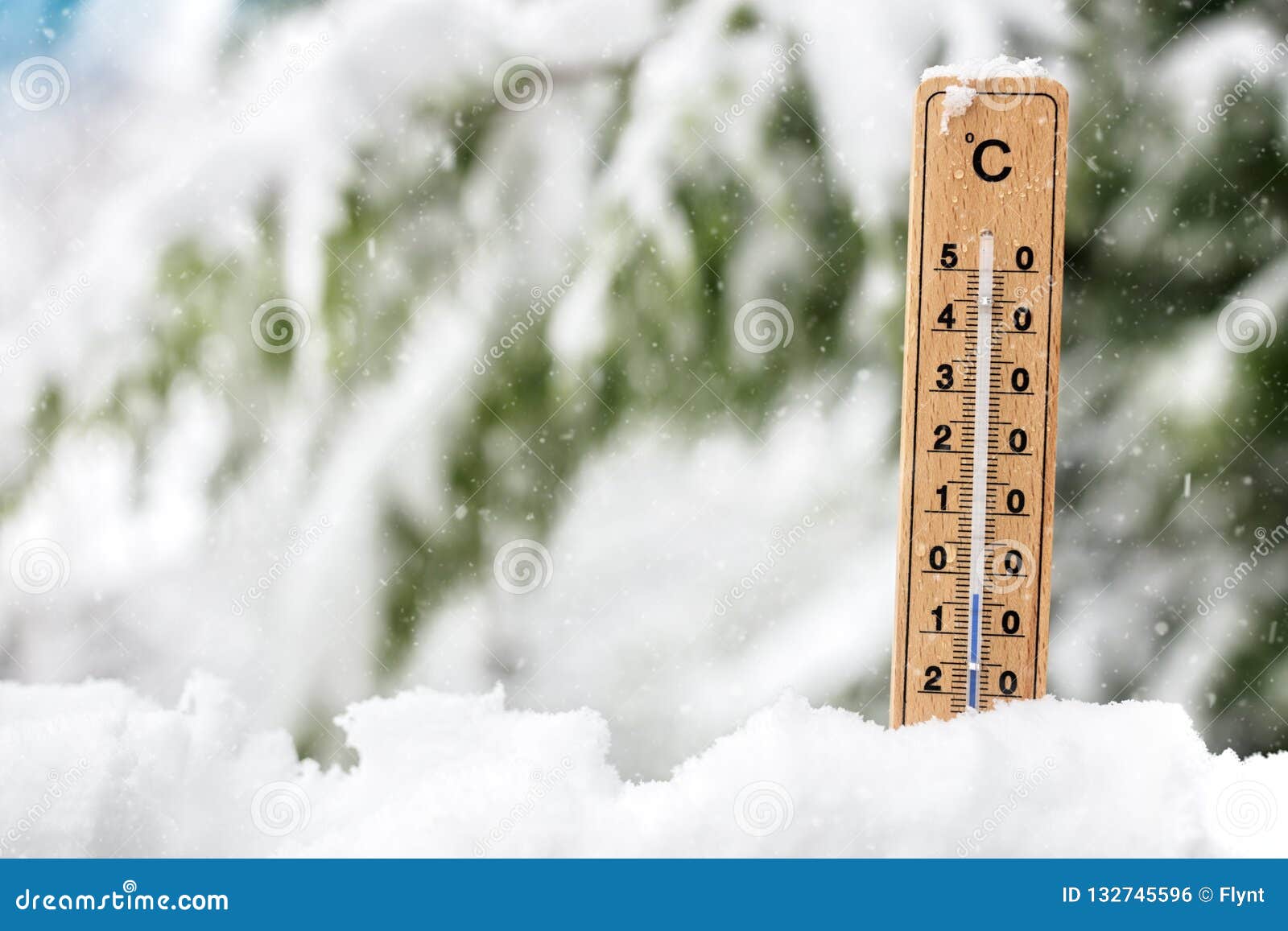 thermometer showing freezing cold temperature in the snow