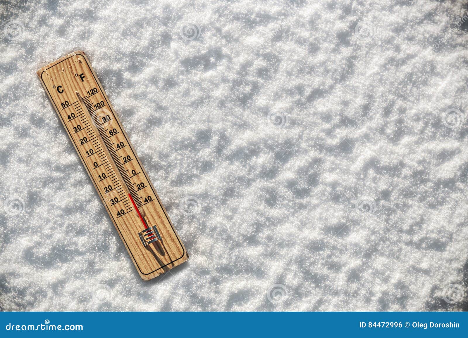thermometer in the snow with freezing temperatures