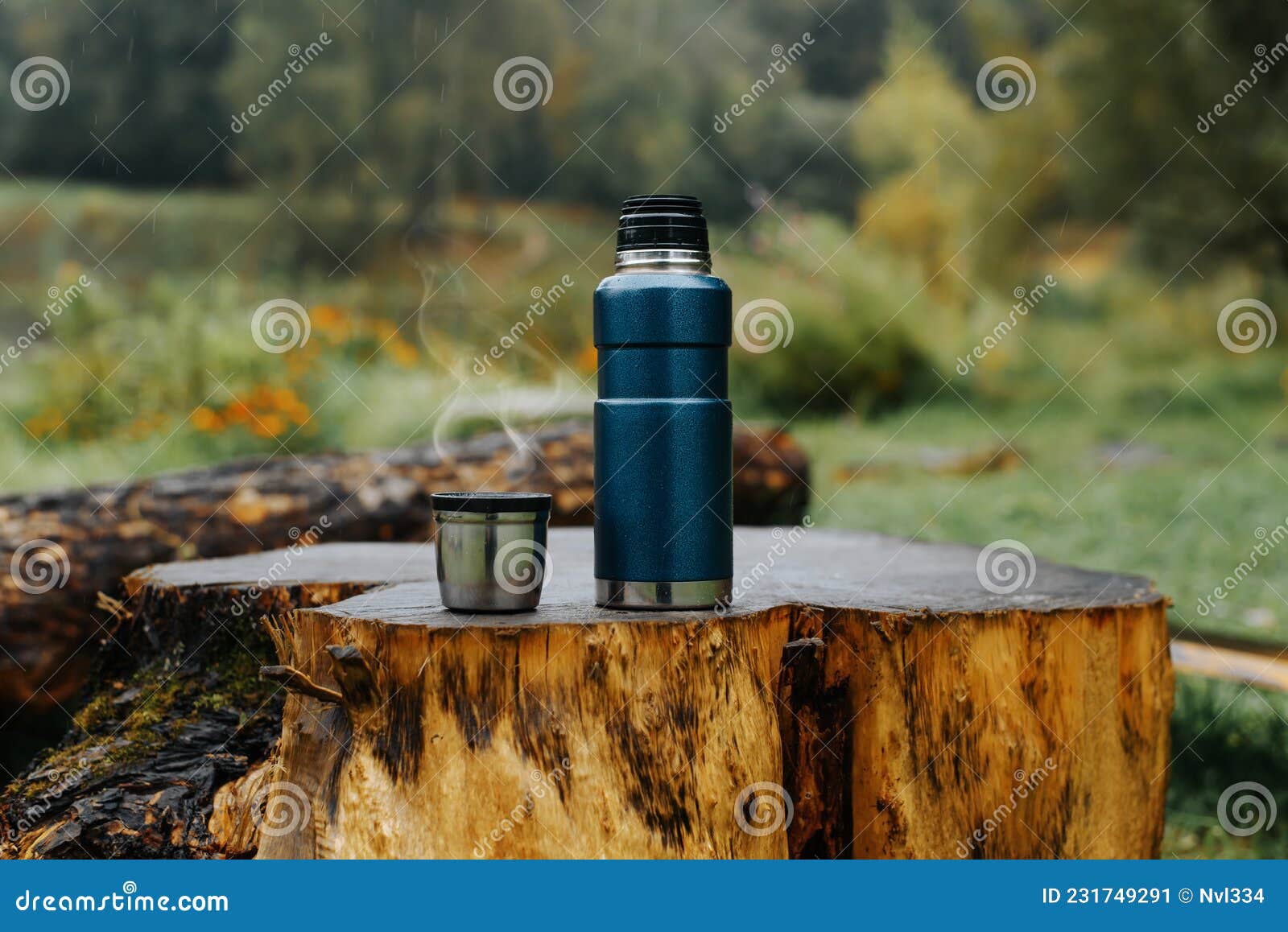 Aluminium Thermos with Hot Drink on Rock Stone Outdoors. Space for