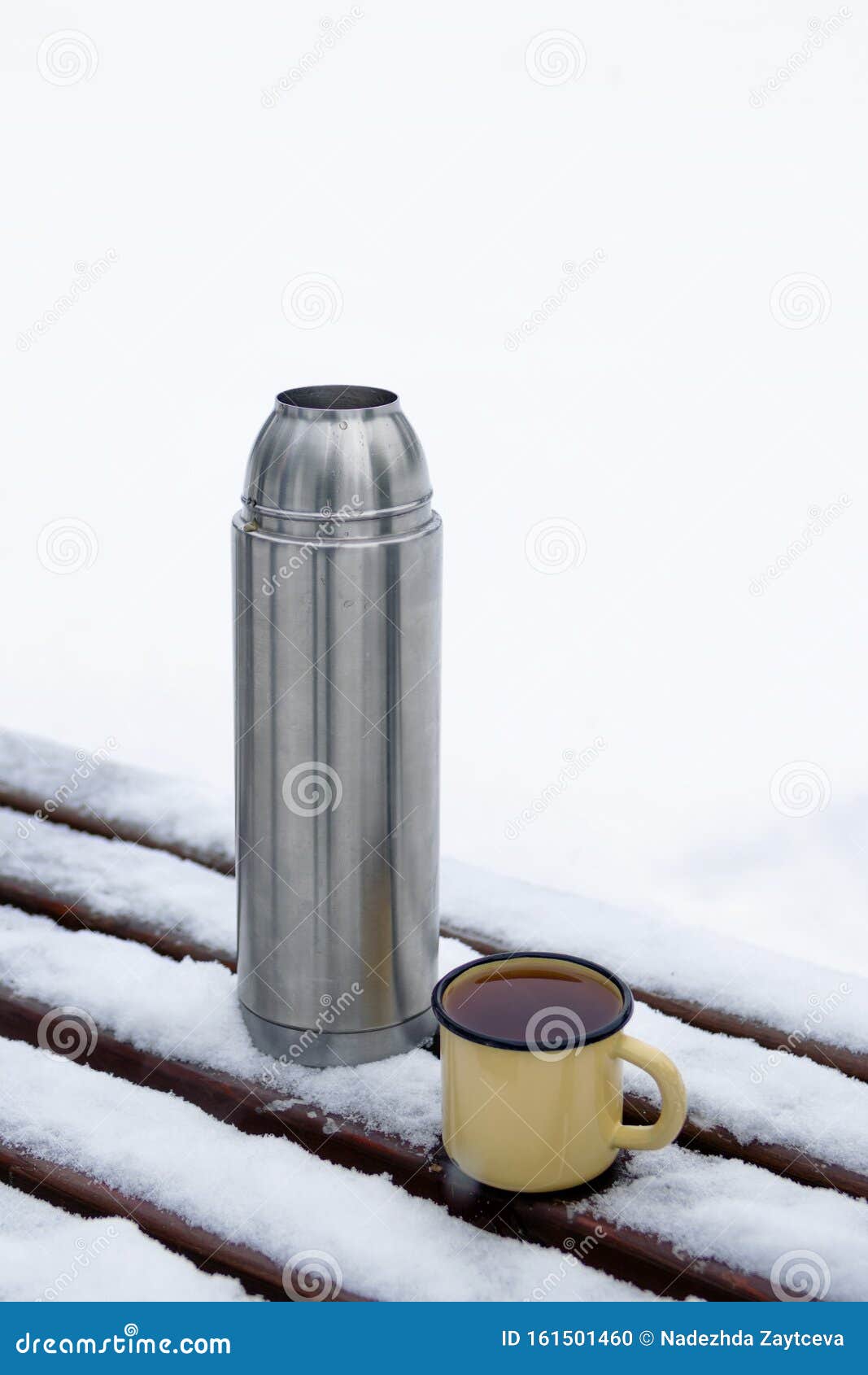 Thermos and Metal Cup with Hot Tea on a Snow-covered Bench in a Winter Park  Stock Photo - Image of space, flask: 161501460