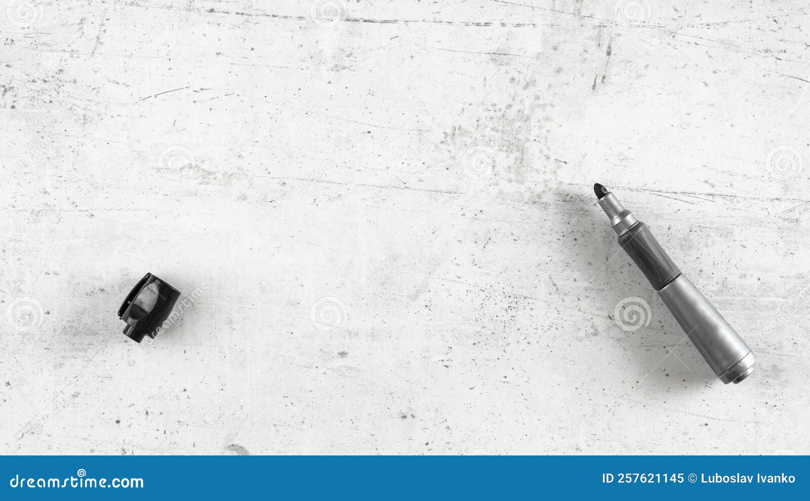 Thick Black Marker Pen with Opened Cap on White Stone Like Board