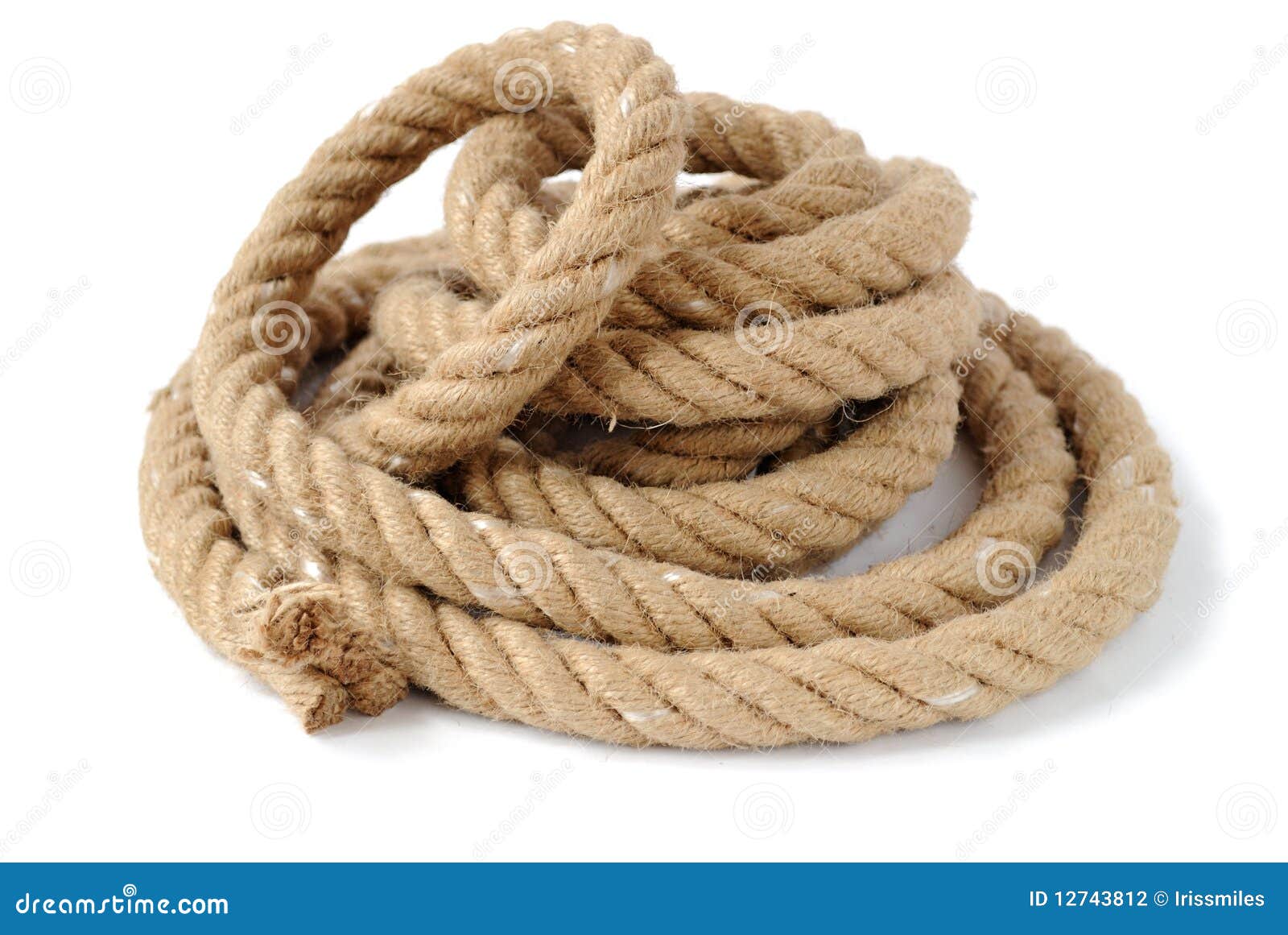 A coil of thick shipping rope on the stone floor of a shed