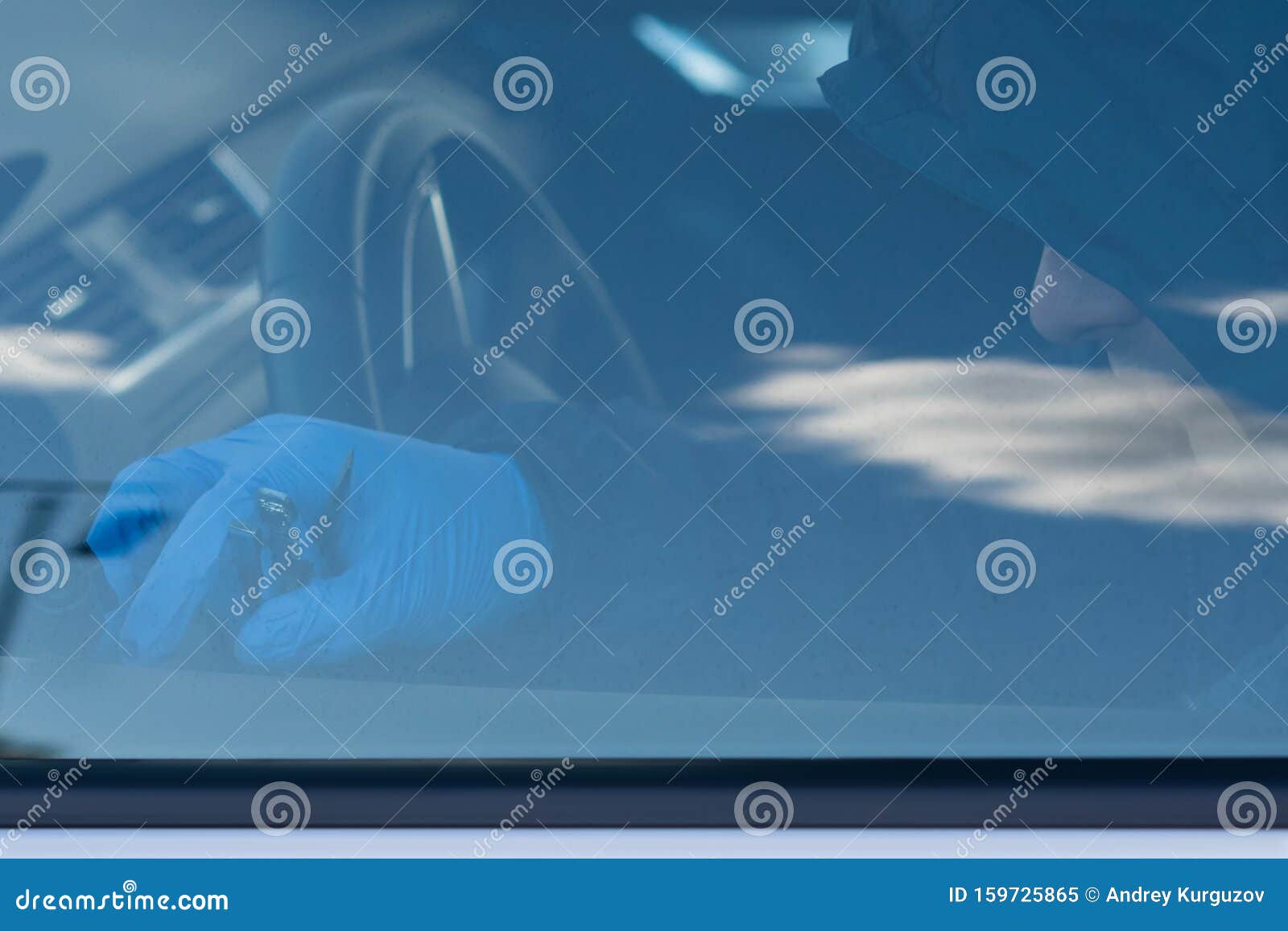 A Thief in the Car Breaks the Ignition System for Theft Stock Image