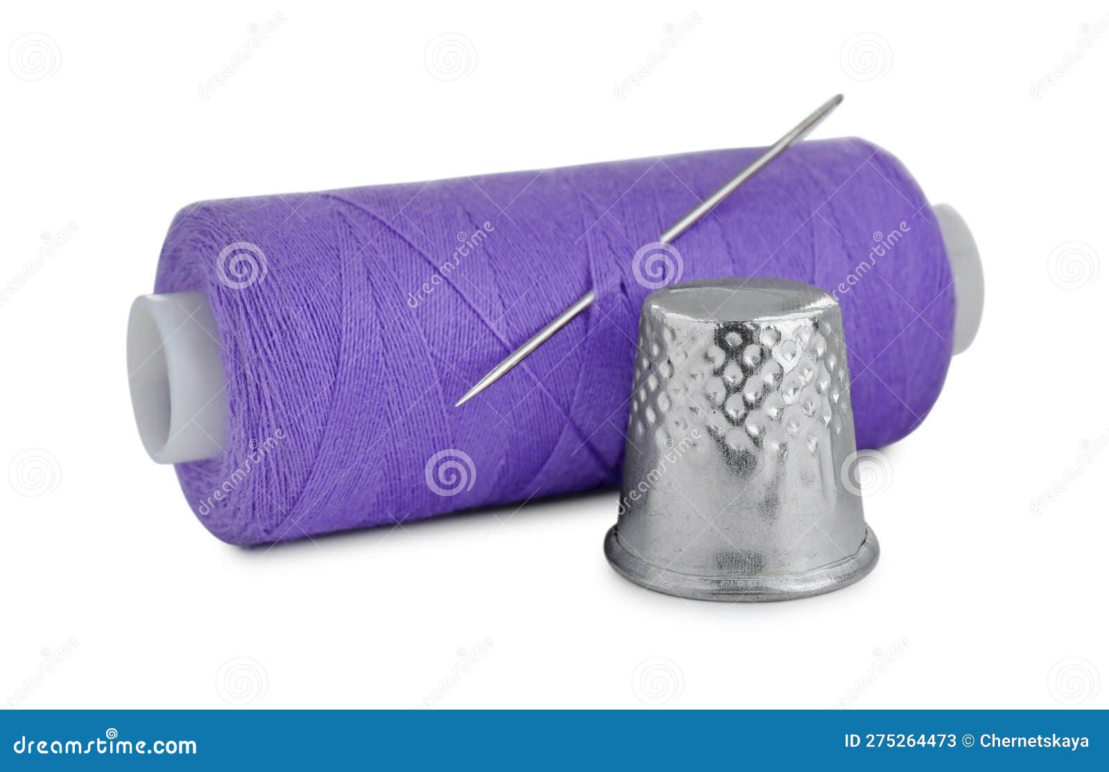 Thimble and Spool of Purple Sewing Thread with Needle Isolated on White