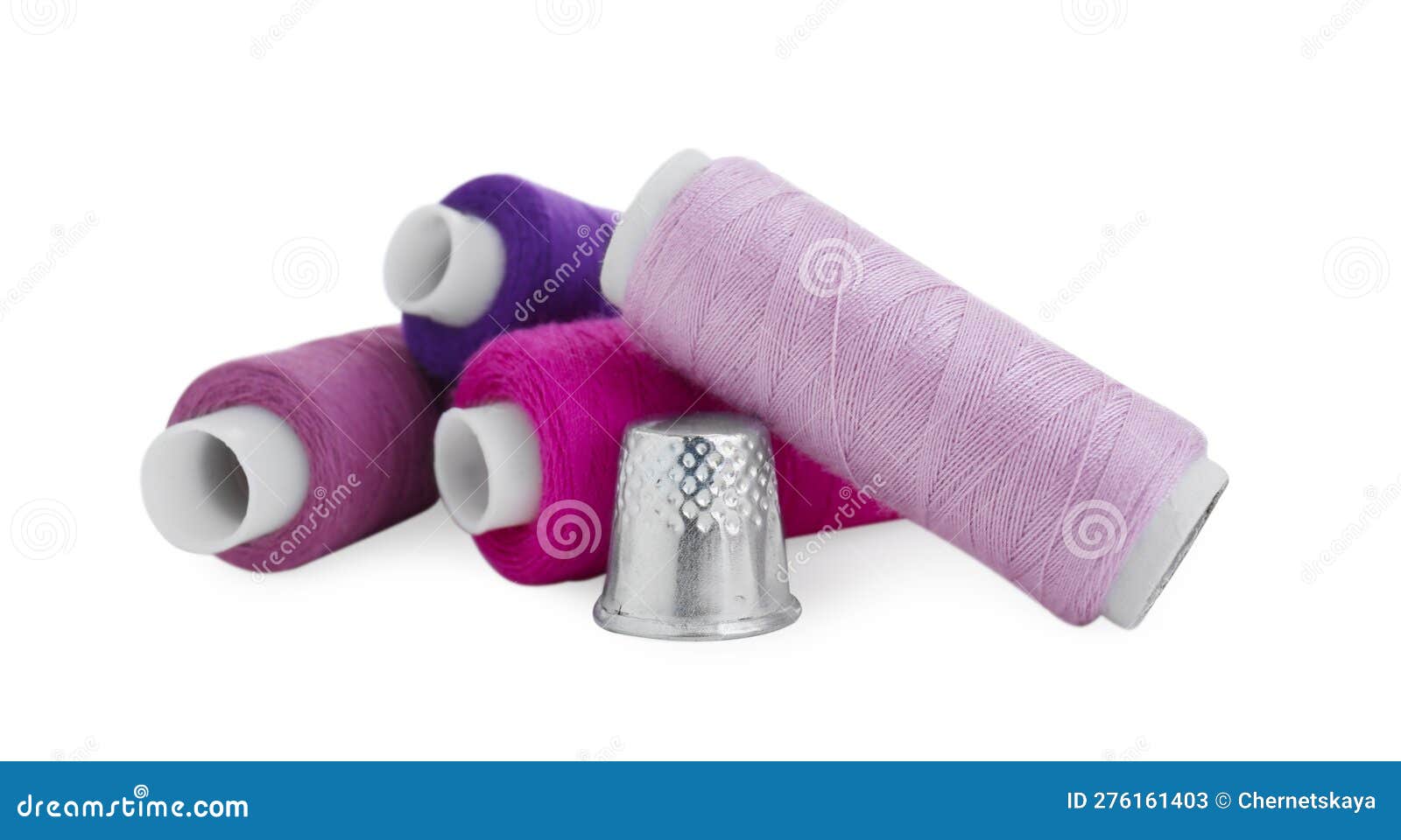 Thimble and Spools of Sewing Thread Isolated on White Stock Image