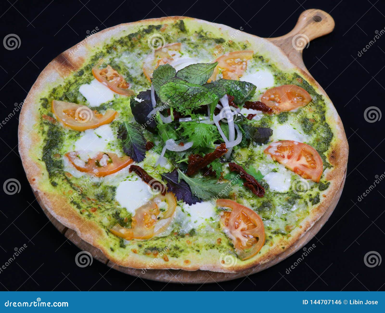 Thin Crust Pizza with Basil Pesto and Tomato, Also Known As Lagara ...