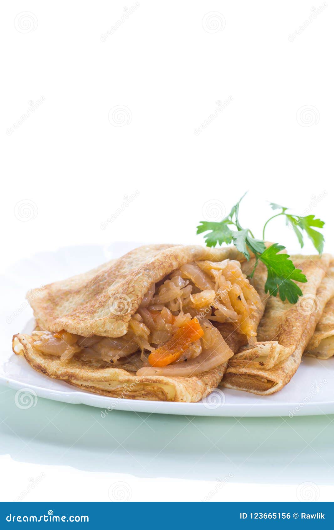 Thin Fried Pancakes Stuffed with Stewed Cabbage in a Plate Stock Photo