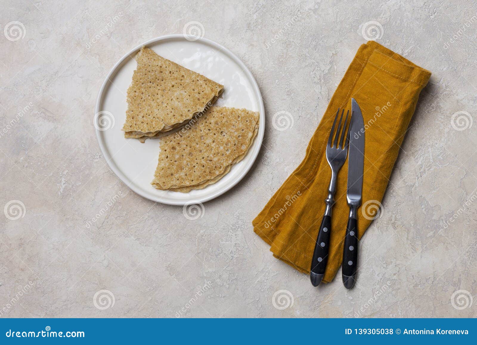 Thin Pancakes With Fork And Knife At White Background Stock Photo