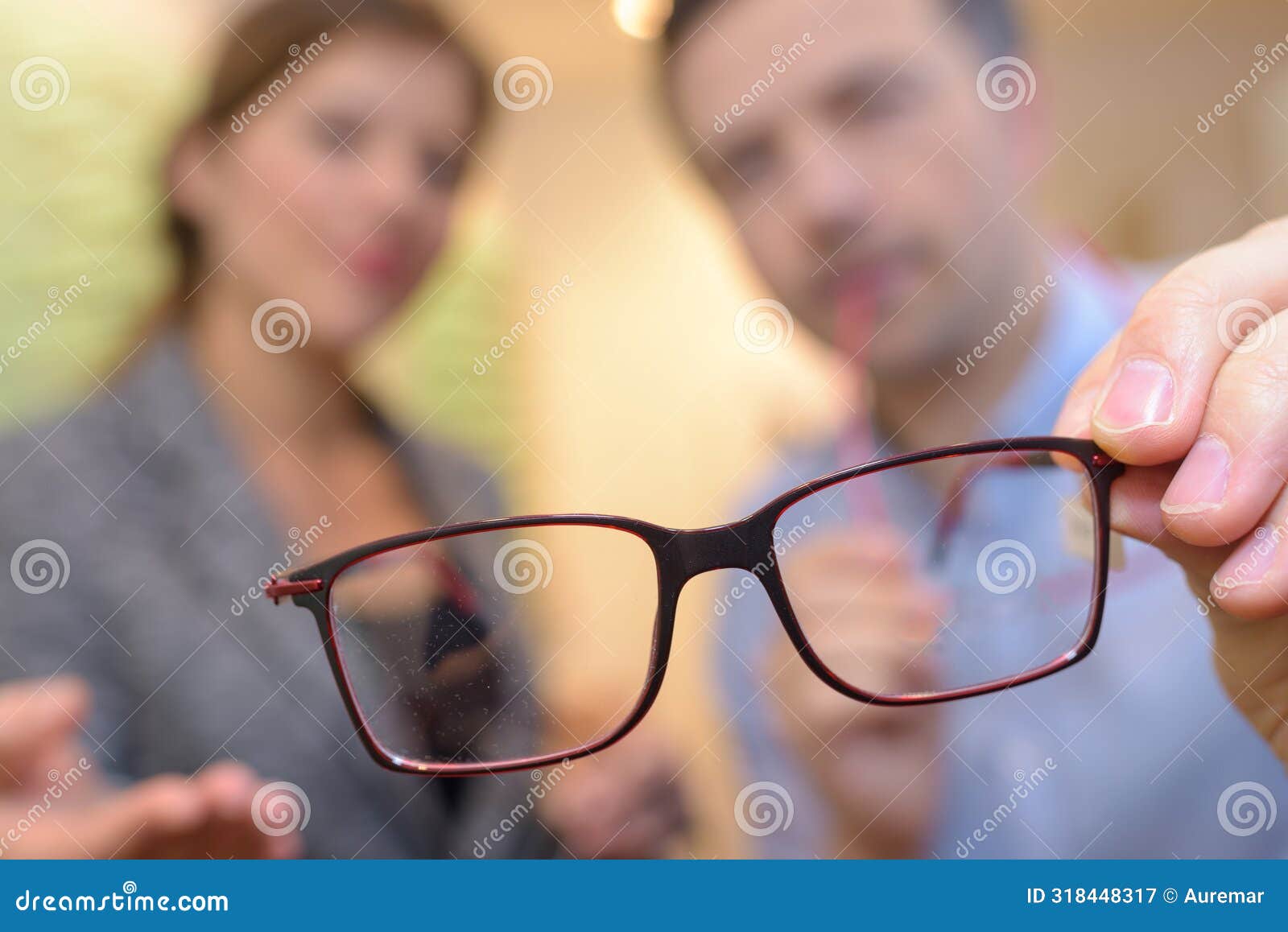 thin wire framed spectacles close focus in optician hands