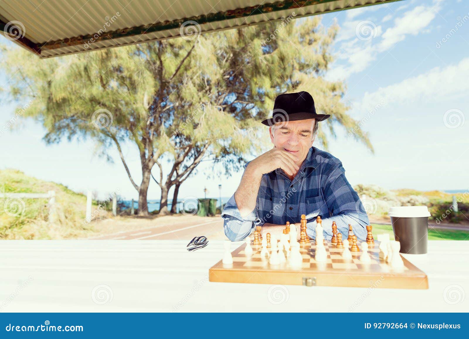 Senior man thinking about his next move in a game of chess Stock Photo by  dmytros9