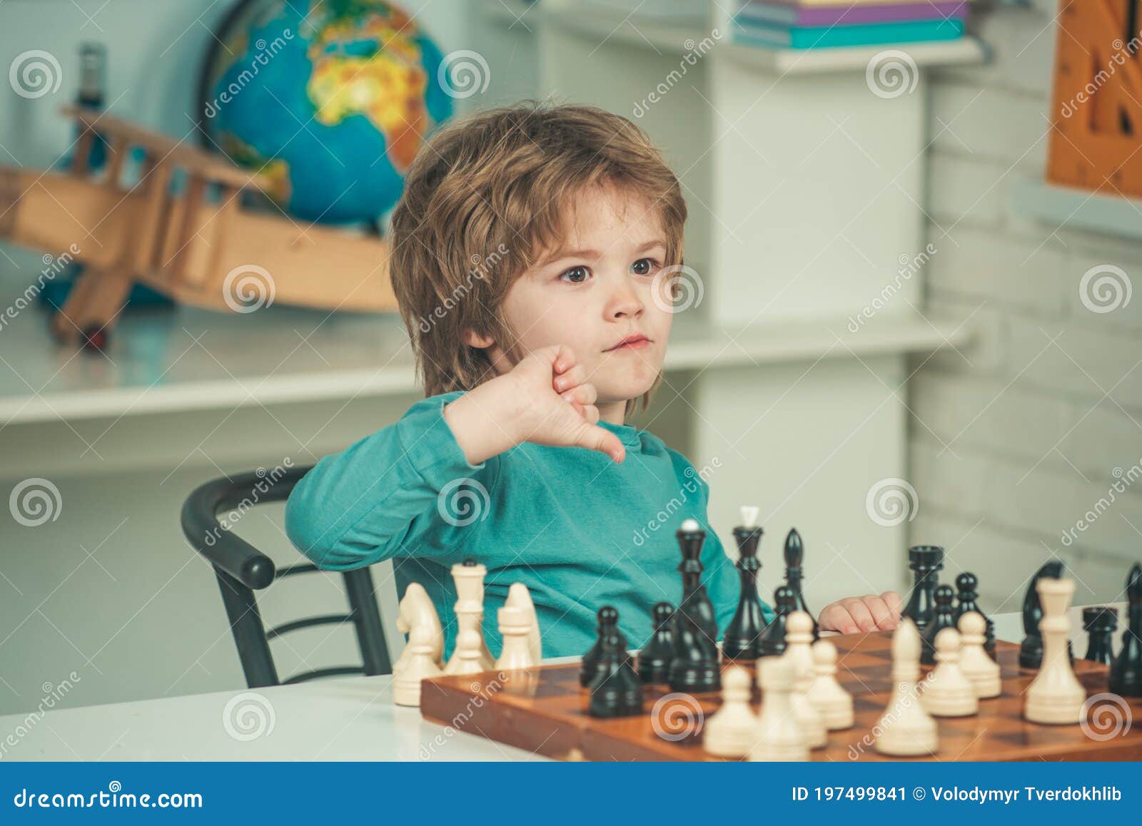 Pupil Kid Thinking About His Next Move In A Game Of Chess. Clever  Concentrated And Thinking Child While Playing Chess. Little Clever Boy  Thinking About Chess. Games Good For Brain Intelligence. Stock