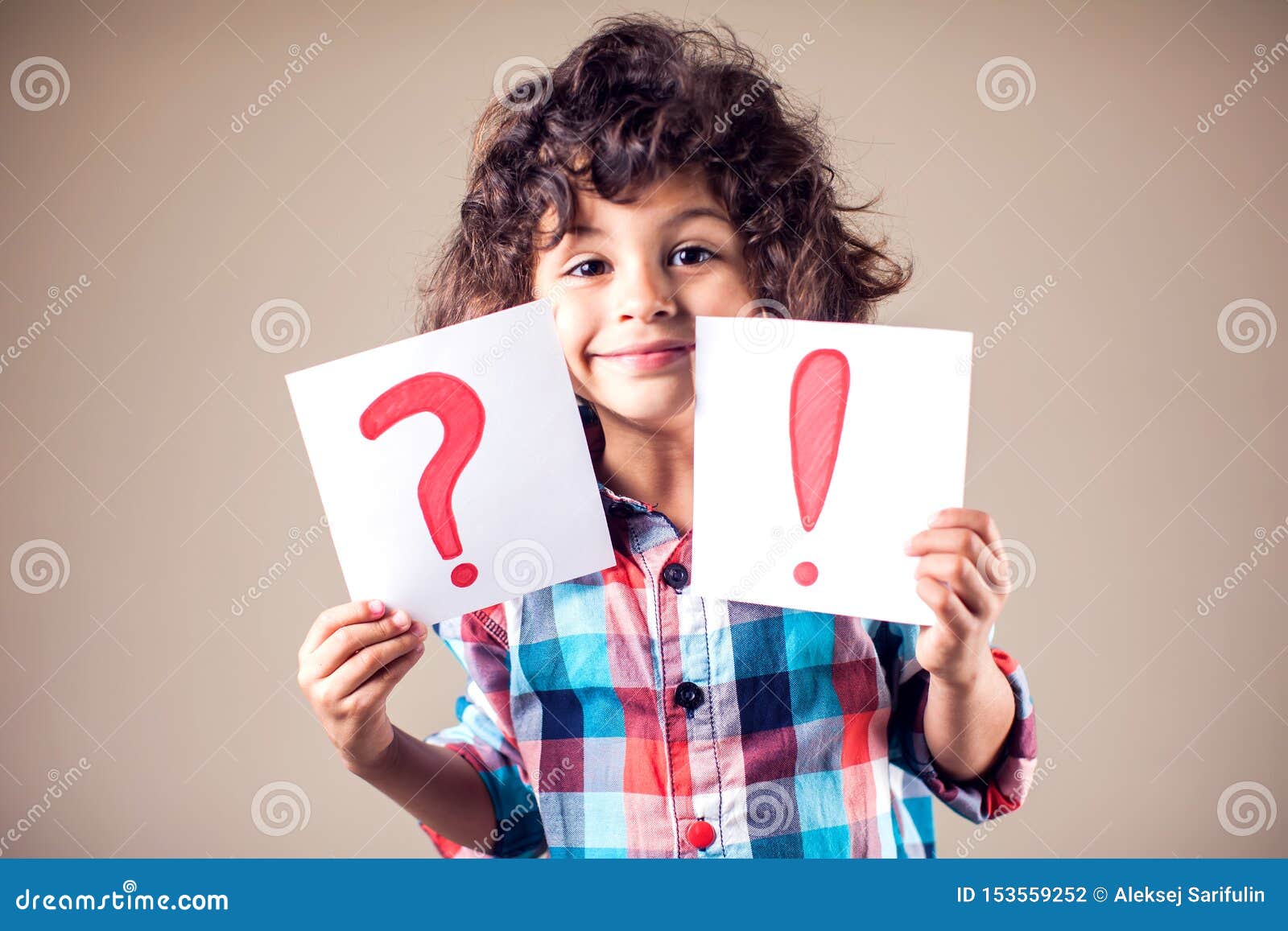 Thinking Kid Boy with Question and Exclamation Signs Stock Photo