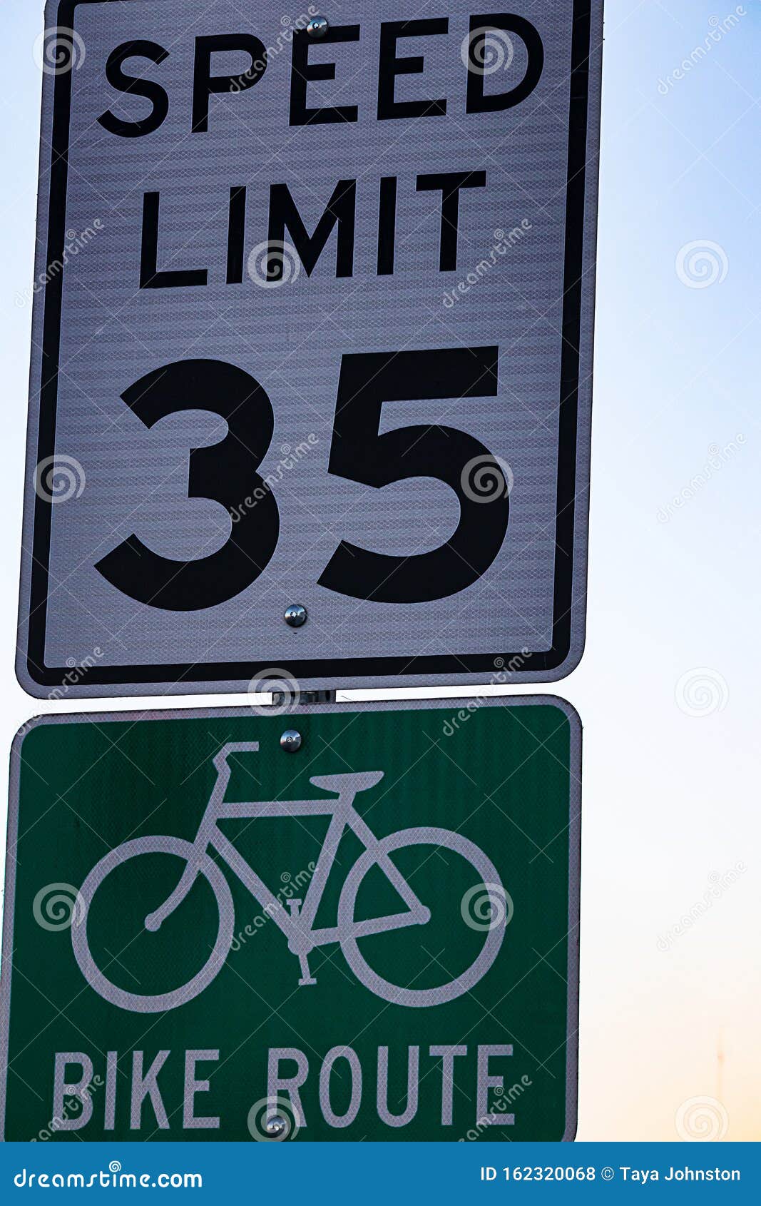 Thirty Five an Hour Speed Limit Sign, and a Bike Route Sign Stock Photo
