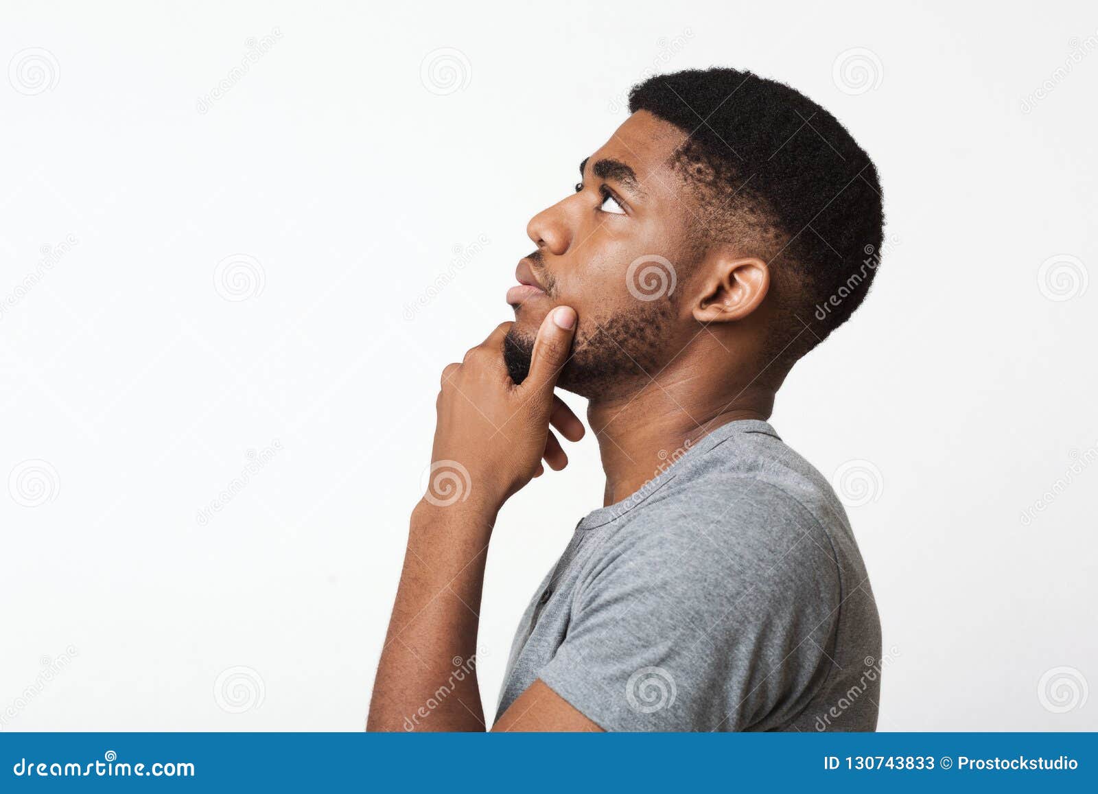 thoughtful african-american man profile portrait on white
