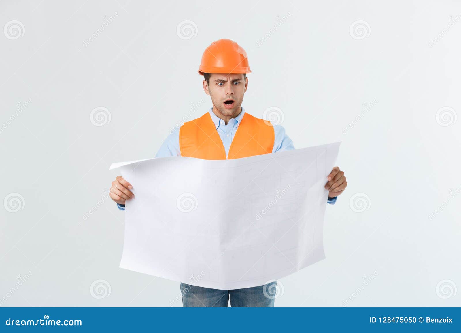 Thoughtful Architect Holding Blueprints Against White Background Stock
