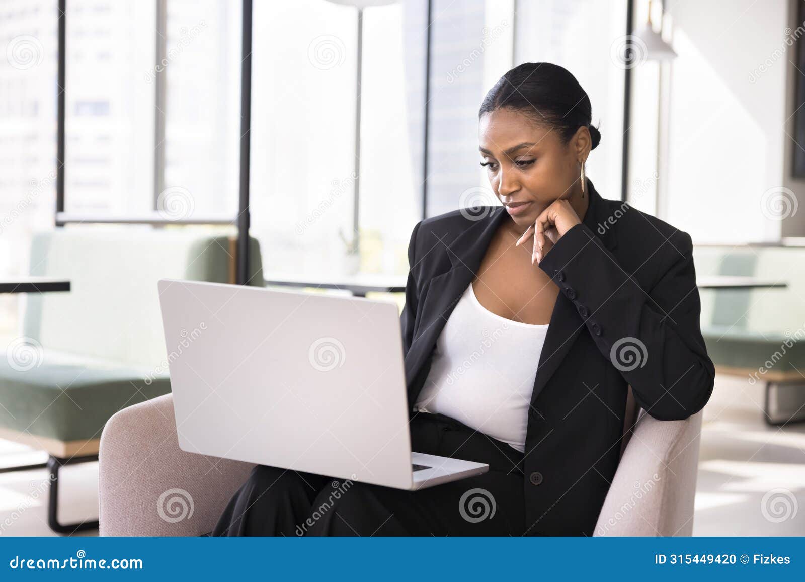 thoughtful beautiful african business specialist woman using laptop