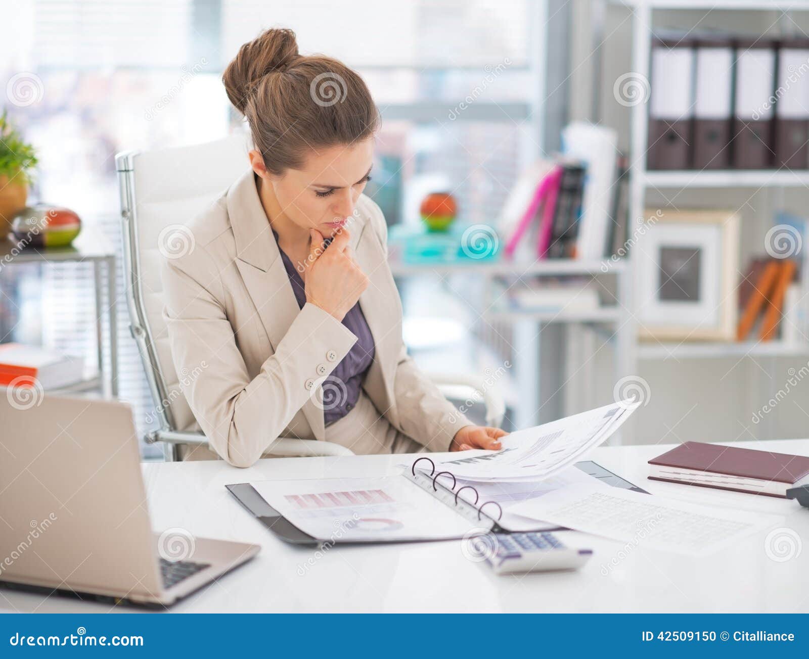 thoughtful business woman documents in office